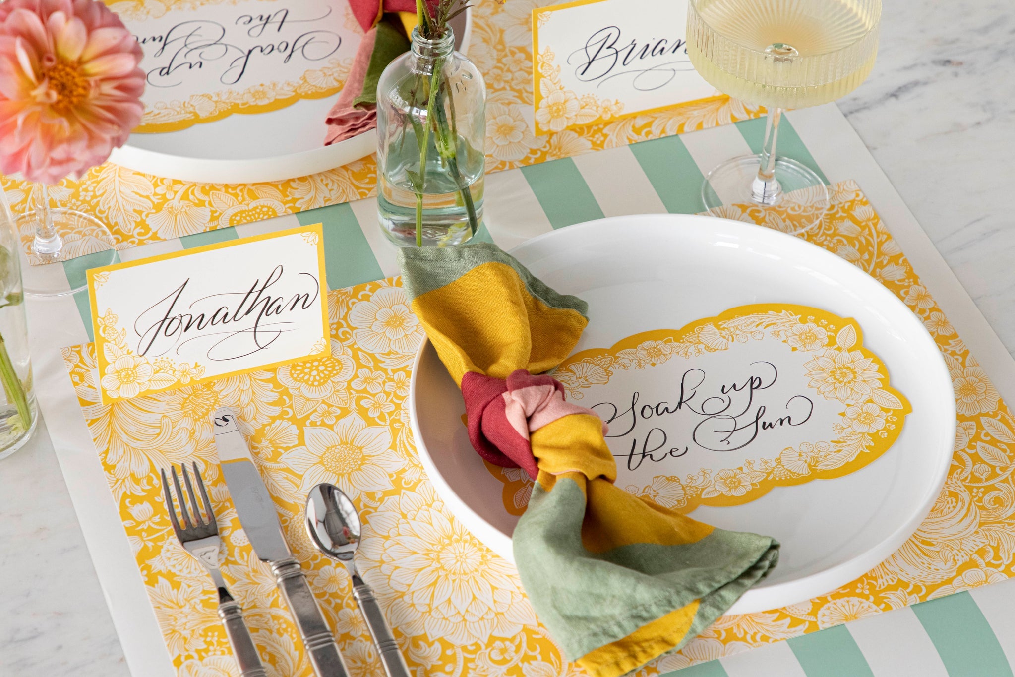 Table setting with floral placemat, table accent and napkin.