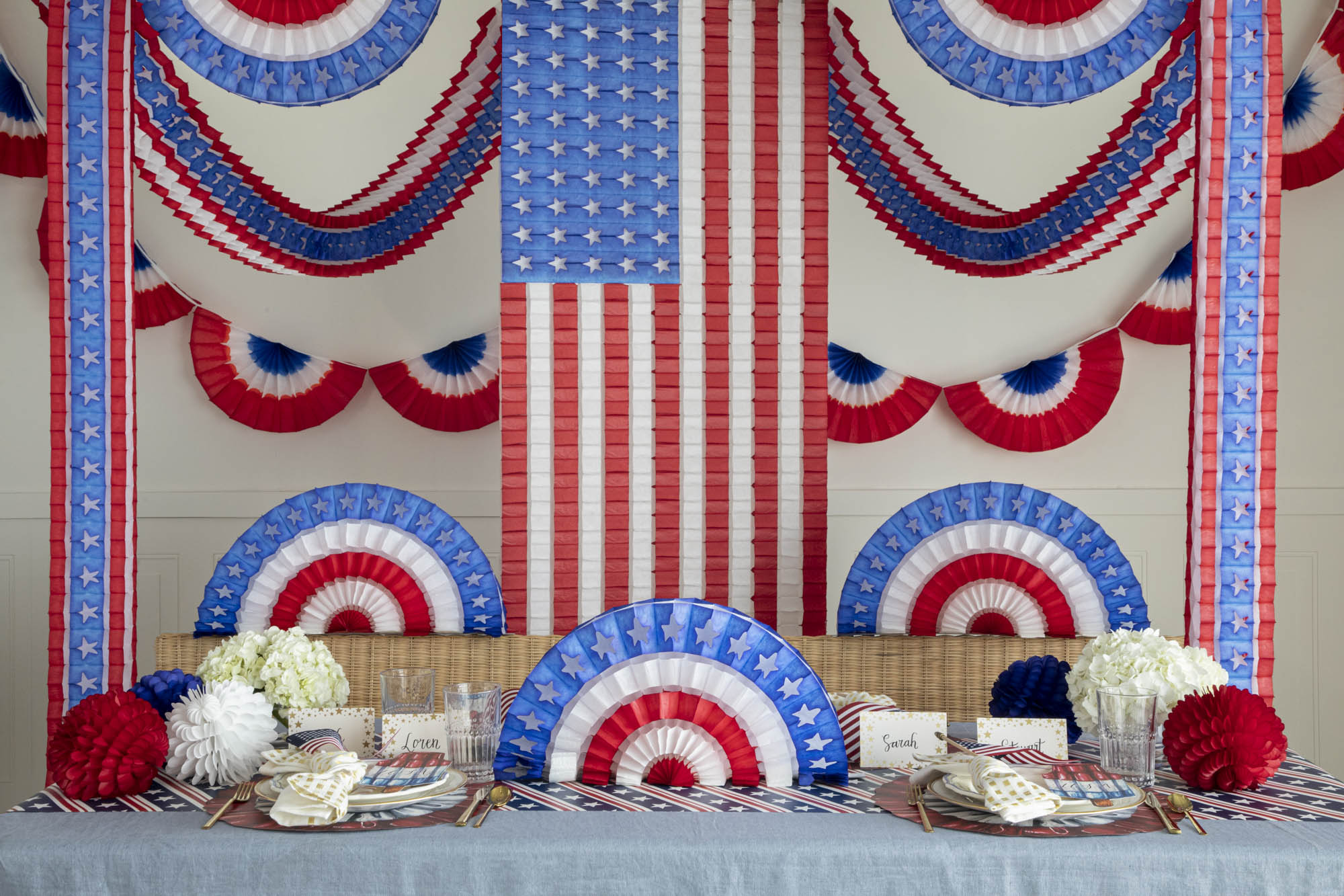 A patriotic table set up with red, white and blue decorations.