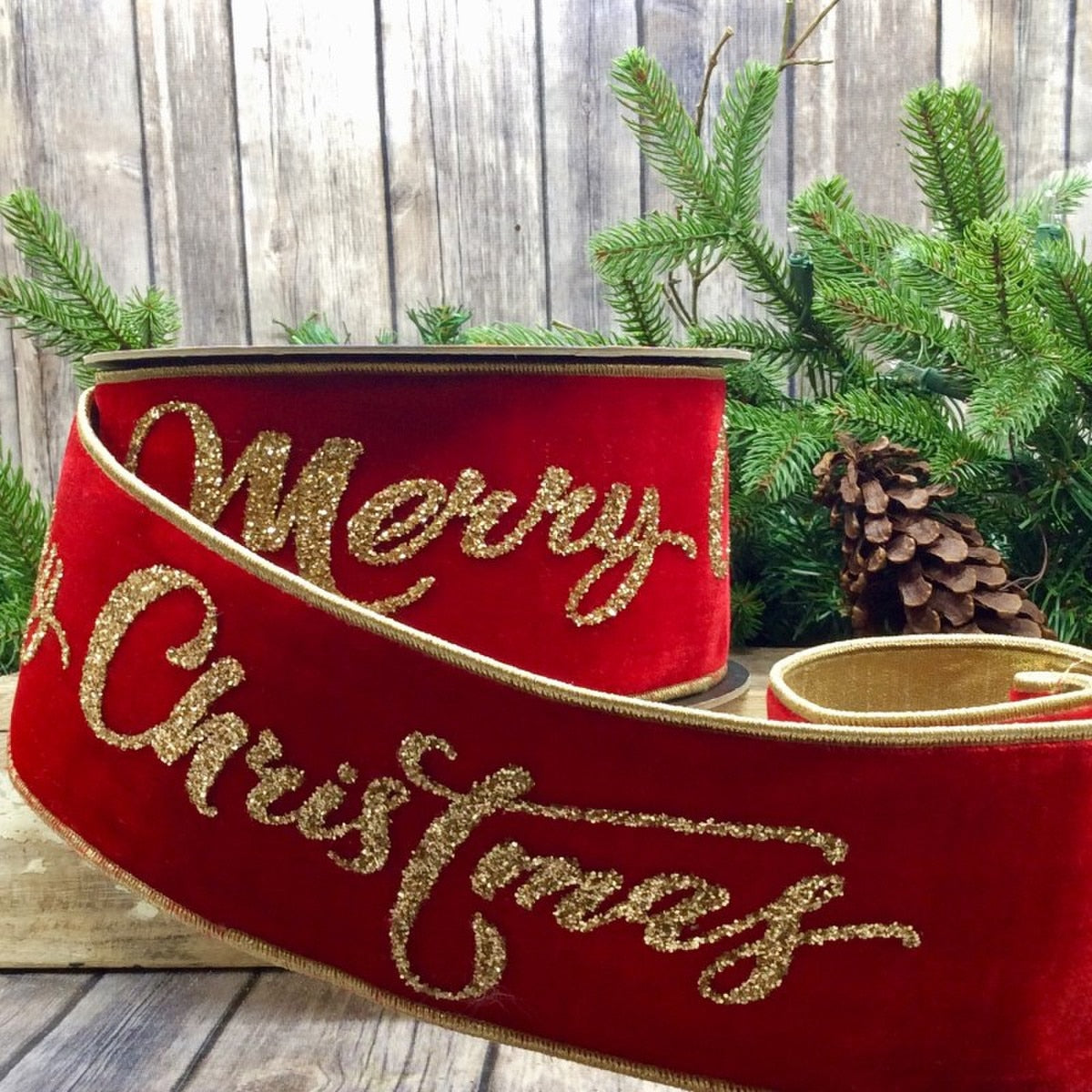 Red Velvet Ribbon with gold glitter on it saying "Merry Christmas" .
