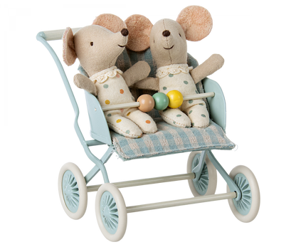 Plush rabbit toys staged in a dollhouse setting with a miniature crib, lamp, and Maileg Baby Mice Stroller.
