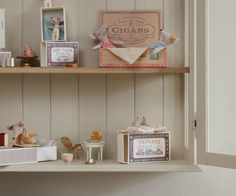 A Maileg Matchbox filled with Baby Mice Triplets toys.