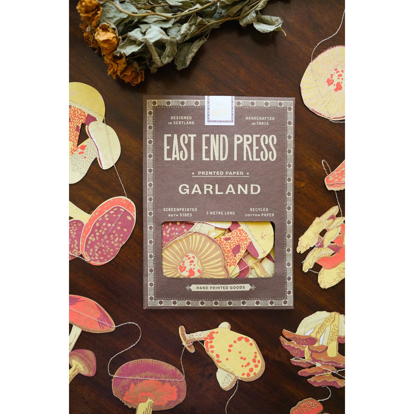 Front of package for the mushroom garland surrounded by the mushroom garland.