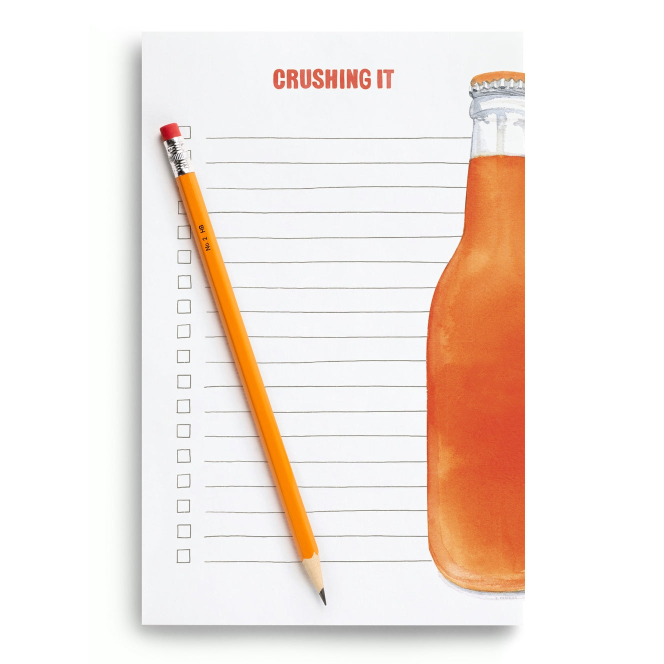 Notepad with a pencil and bottle of orange juice on a white background