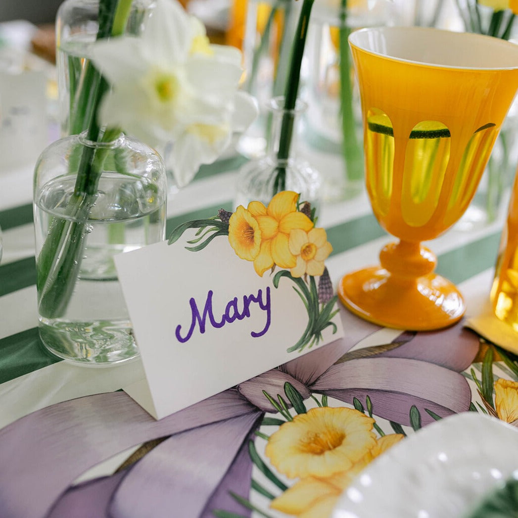 A Daffodil Place Card labeled "Mary" in an elegant place setting.