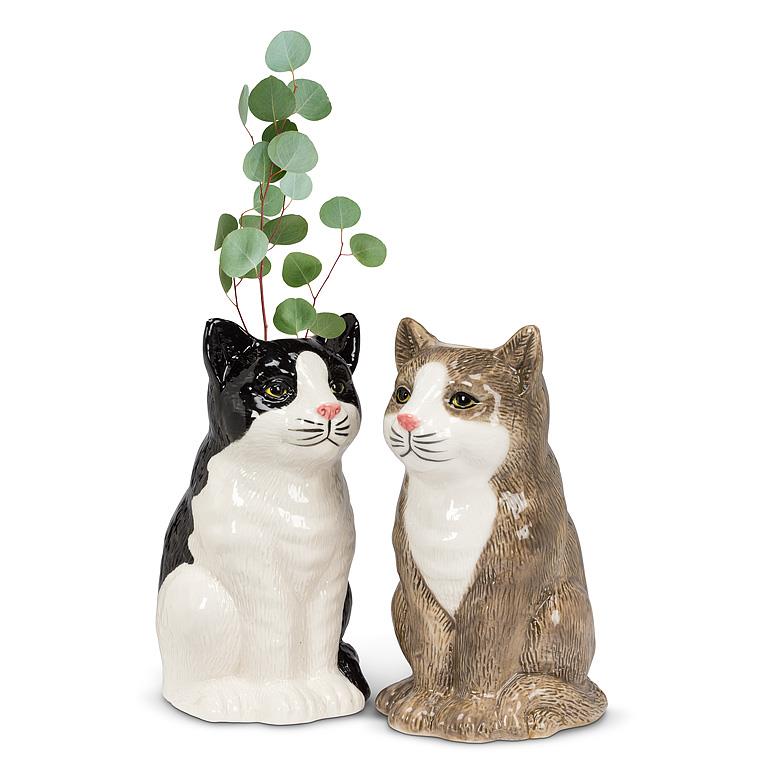 Two cat-shaped vases on a white background, one in black and white, one in brown and white.