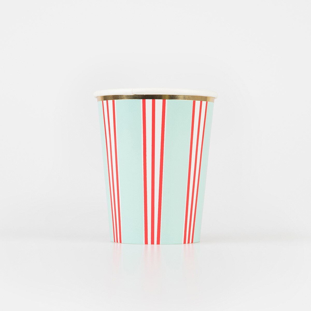 A paper party cup with a light blue background, vertical red and white stripes, and a metallic gold rim, set against a plain white background.