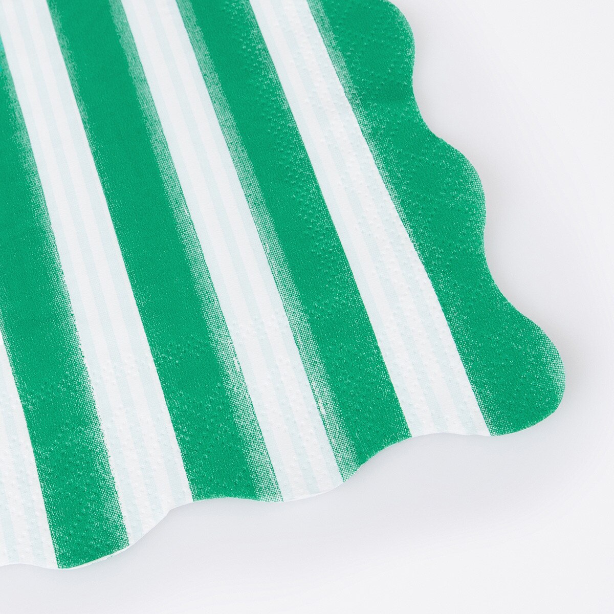 Close-up of green and white striped paper napkin.