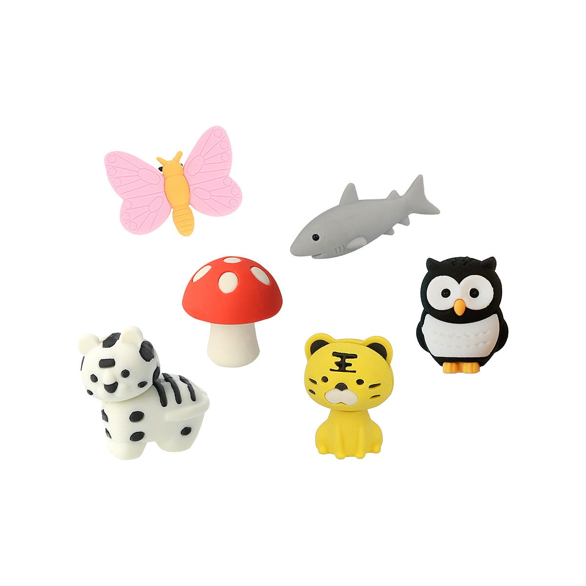 A group of erasers that are shaped to look like a mushroom, owl, pink butterfly, yellow tiger, shark and a zebra.
