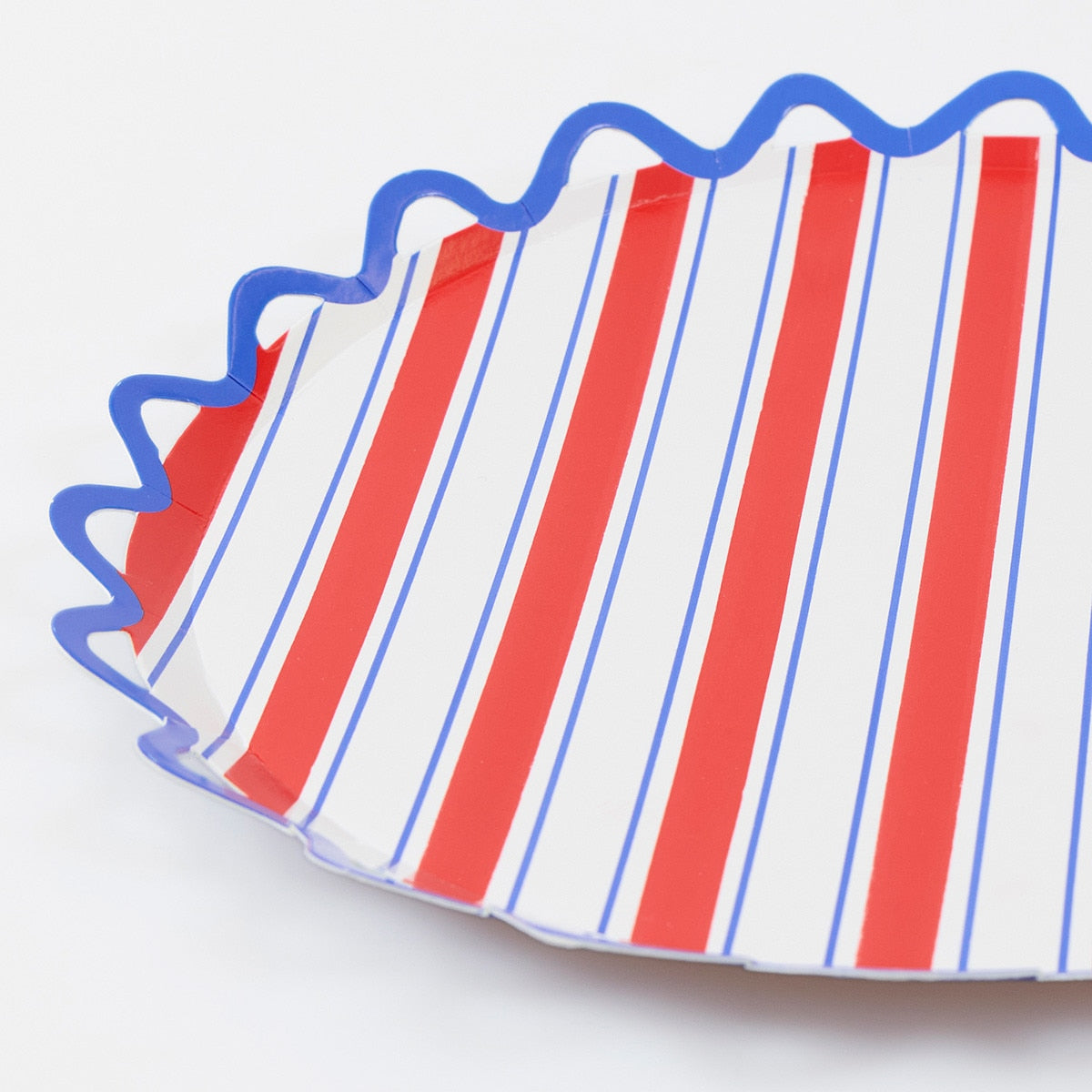 Red and white striped paper plate with blue decorative border on a white background.