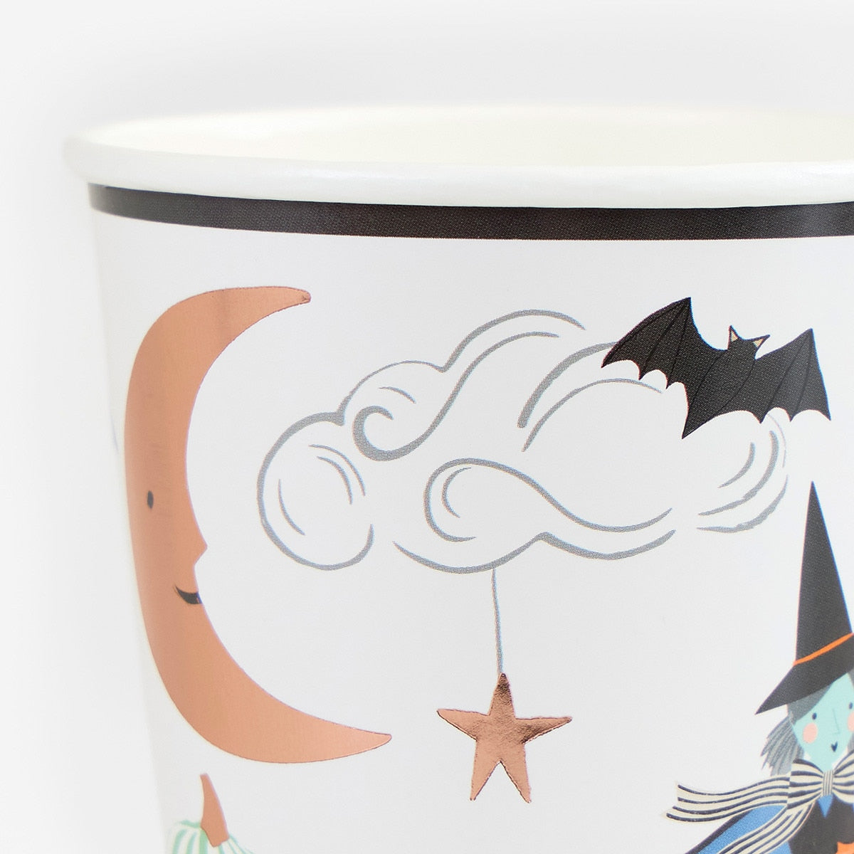 Halloween-themed paper cup with a witch, moon, and bat design on a white background.