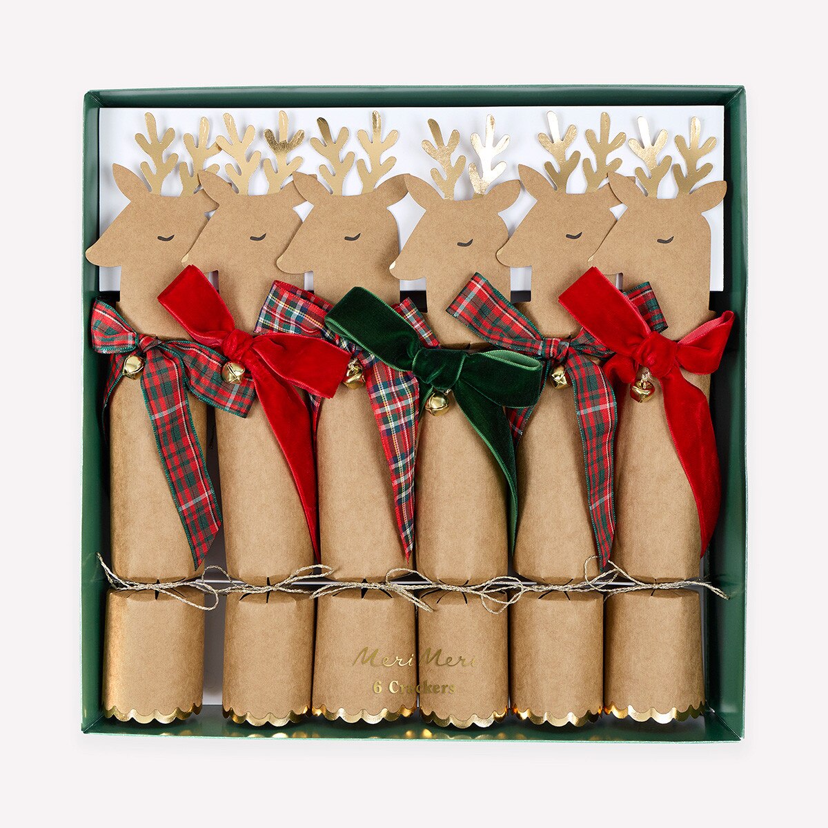 A set of five Christmas cracker ornaments in a dark green gift box. Each cracker is made of natural brown kraft paper, decorated with a reindeer head silhouette, gold antlers, and a ribbon bow in red plaid, red velvet, or green velvet.