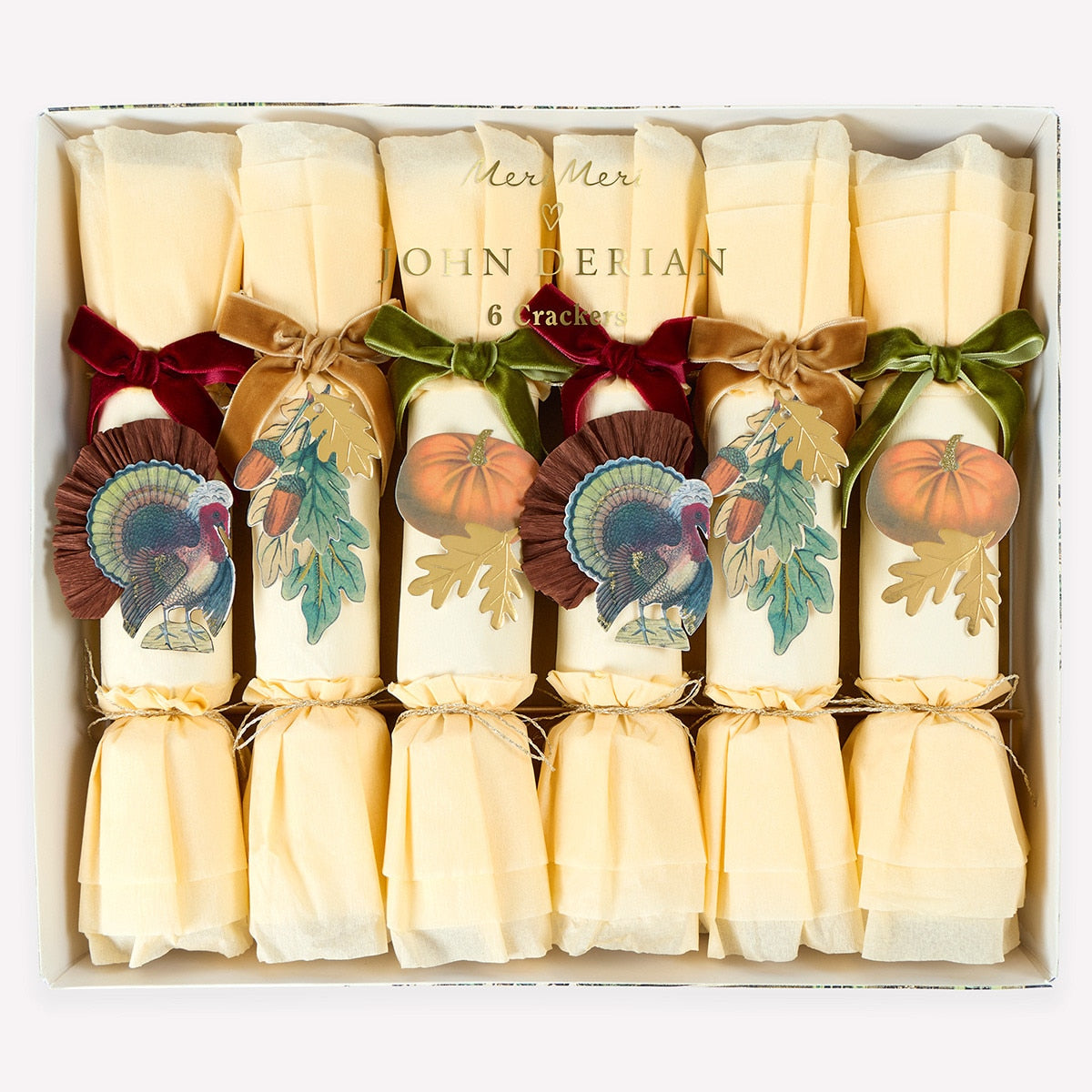 Box of Christmas crackers with festive designs and ribbons.