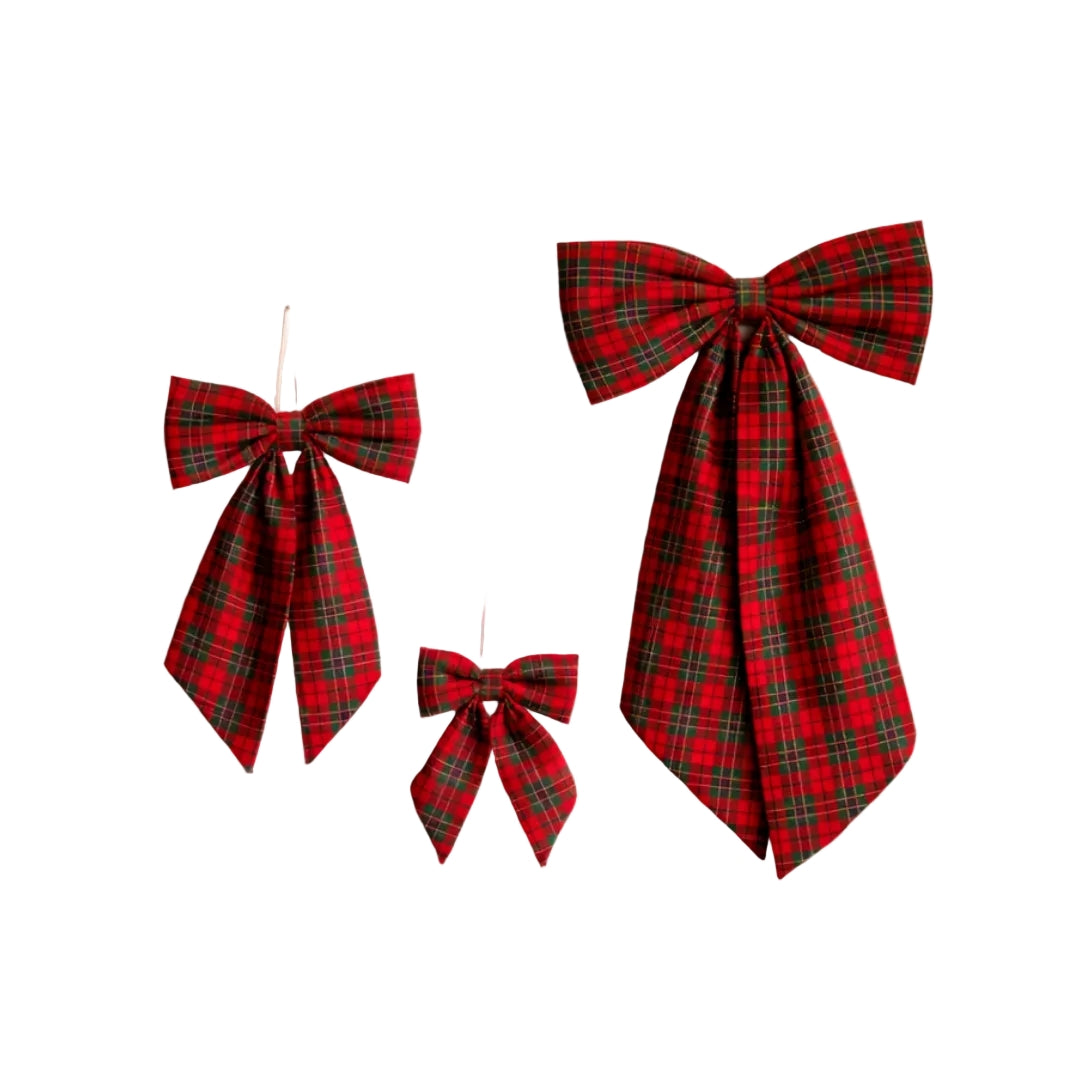 Three red tartan plaid bow decorations of different sizes hanging against a plain white background.