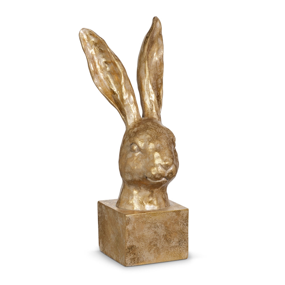 Gold rabbit head sculpture on a white background.