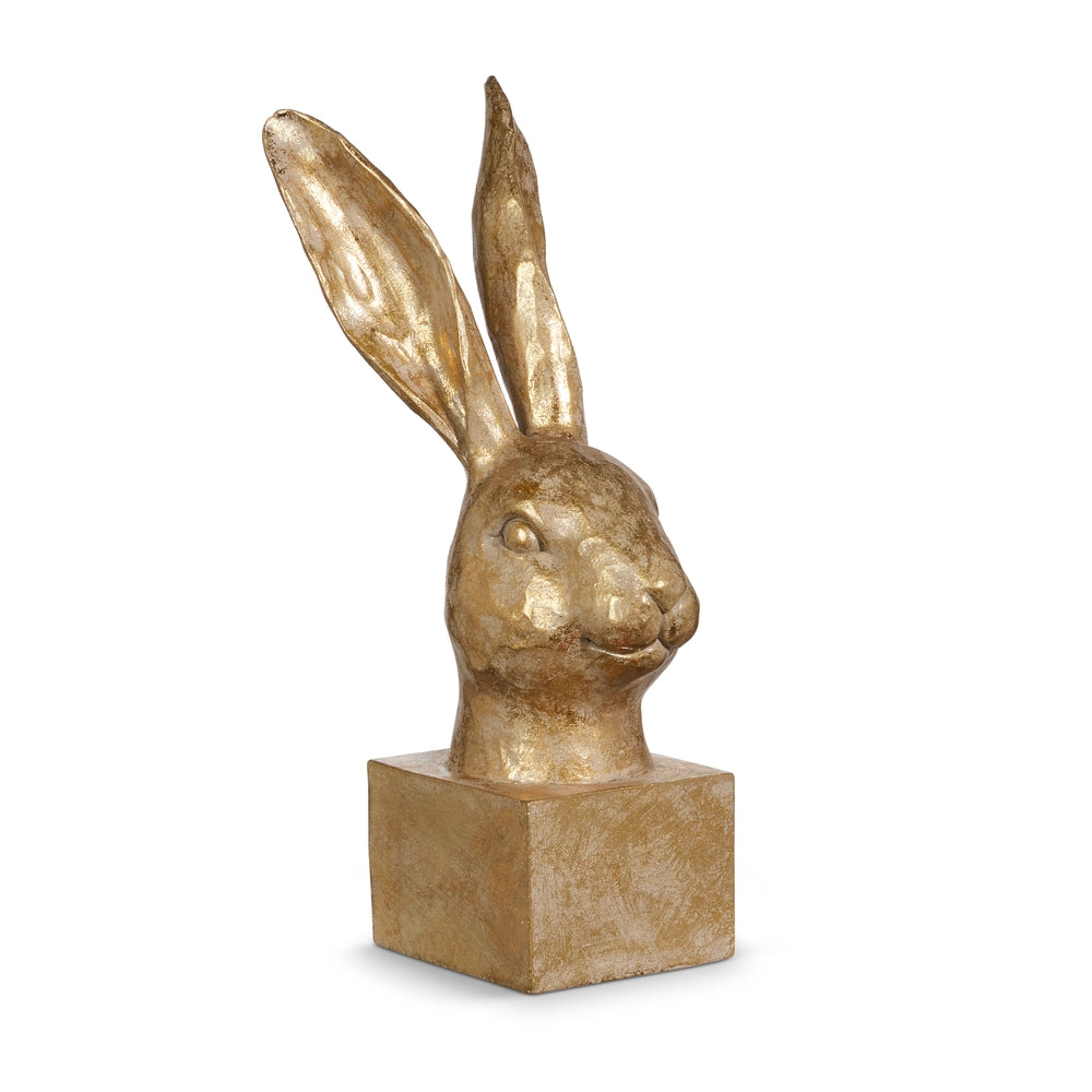 Gold rabbit head sculpture on a white background.