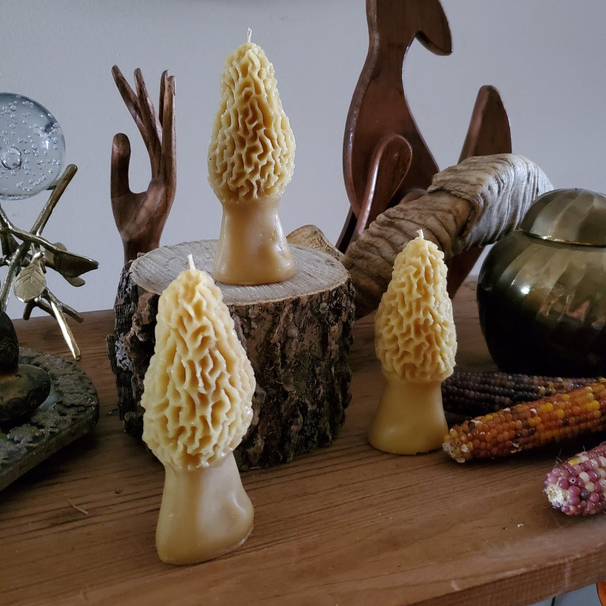 Three morel mushroom candles styled on a table