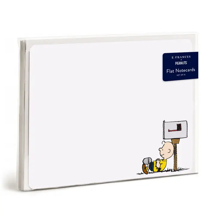 A pack of Peanuts flat notecards by François, featuring a white card design with a small illustration of Charlie Brown sitting next to a mailbox in the lower right corner. A dark blue label in the top right reads &