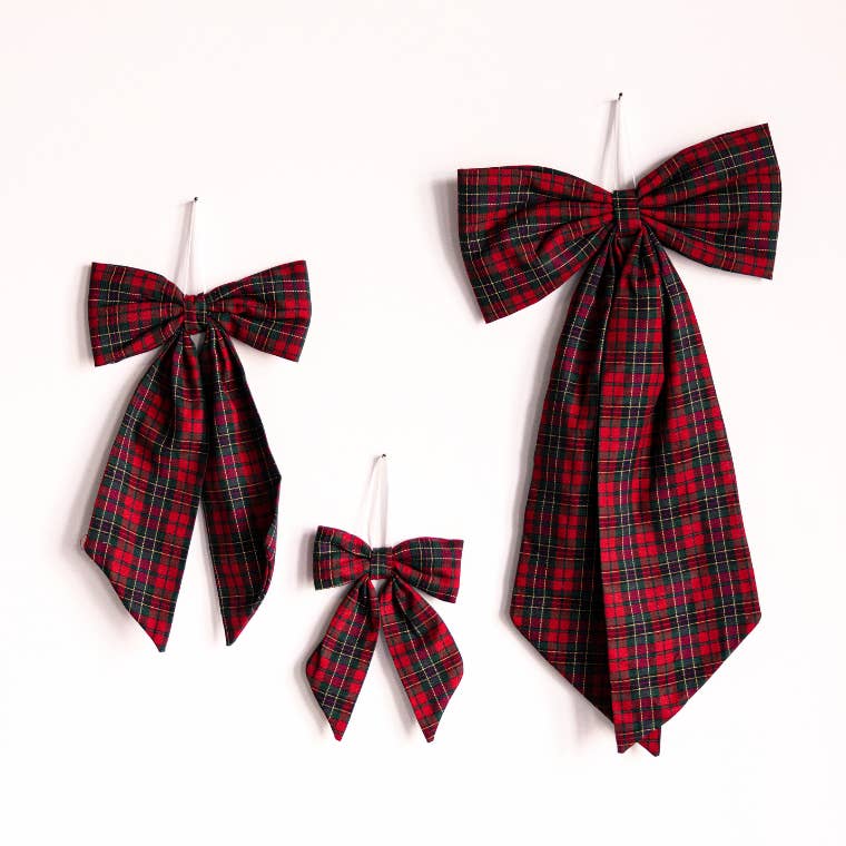 Red and black plaid bows on a white background