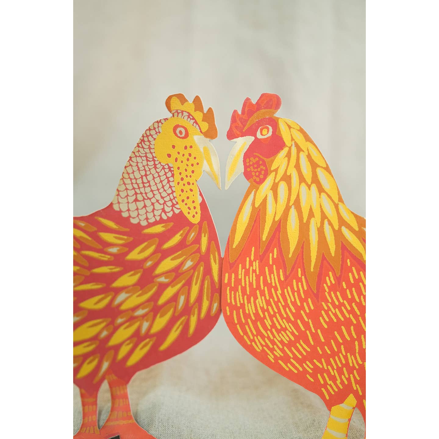 Close up of colorful red and orange chicken garland.