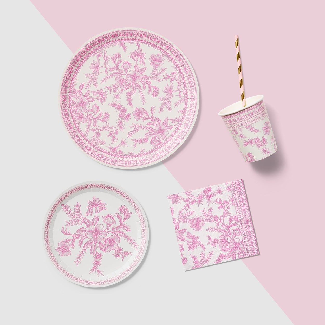 A table set with Pink French Toile Paper Party Dinnerware plates from Coterie Party Supplies featuring floral toile dinnerware patterns that evoke the charm of the French countryside, complemented by silverware.
