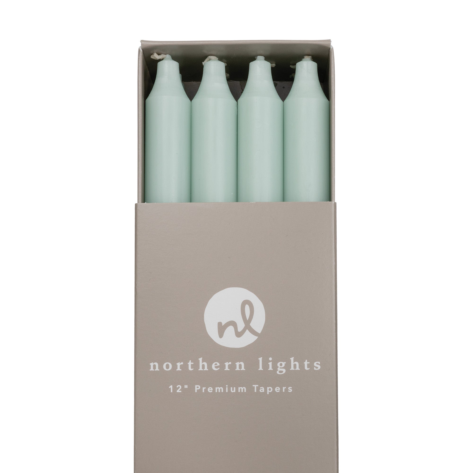 Close-up of a box of pale green taper candles by Northern Lights.