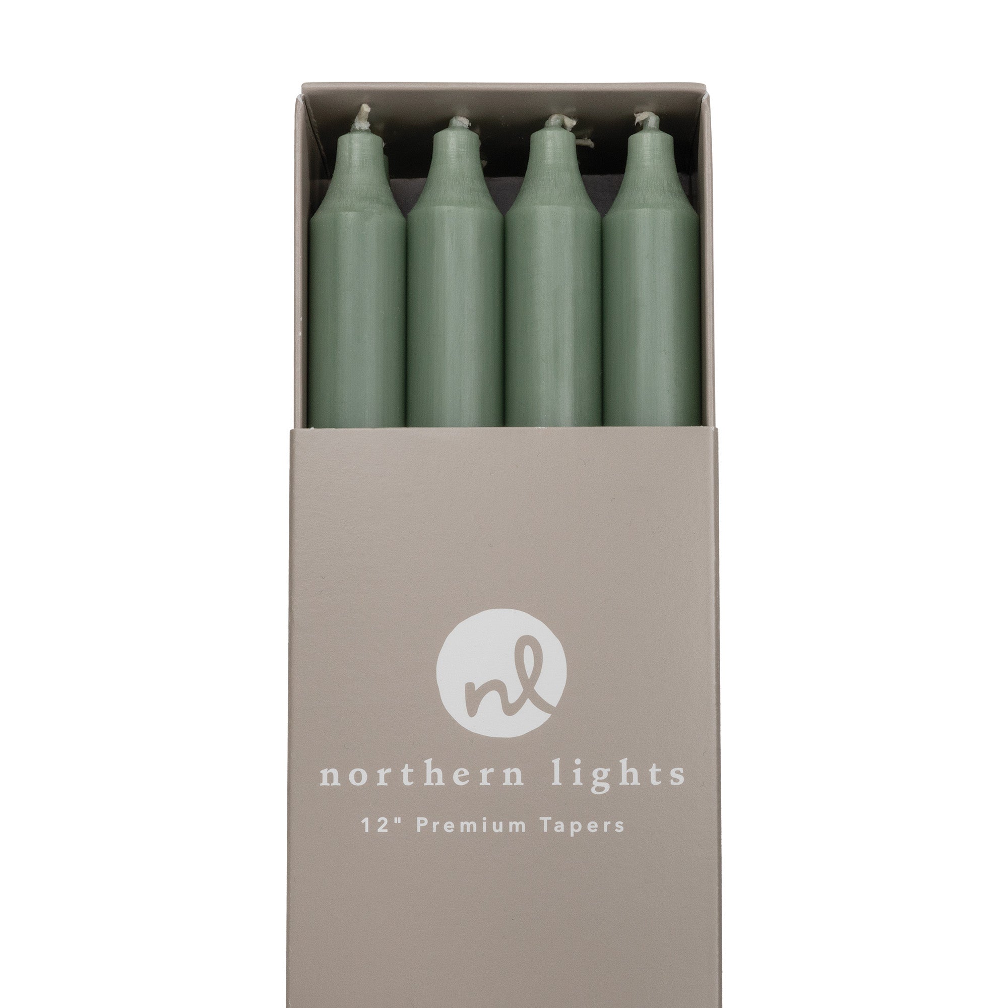 Close-up of a box of green taper candles by Northern Lights.