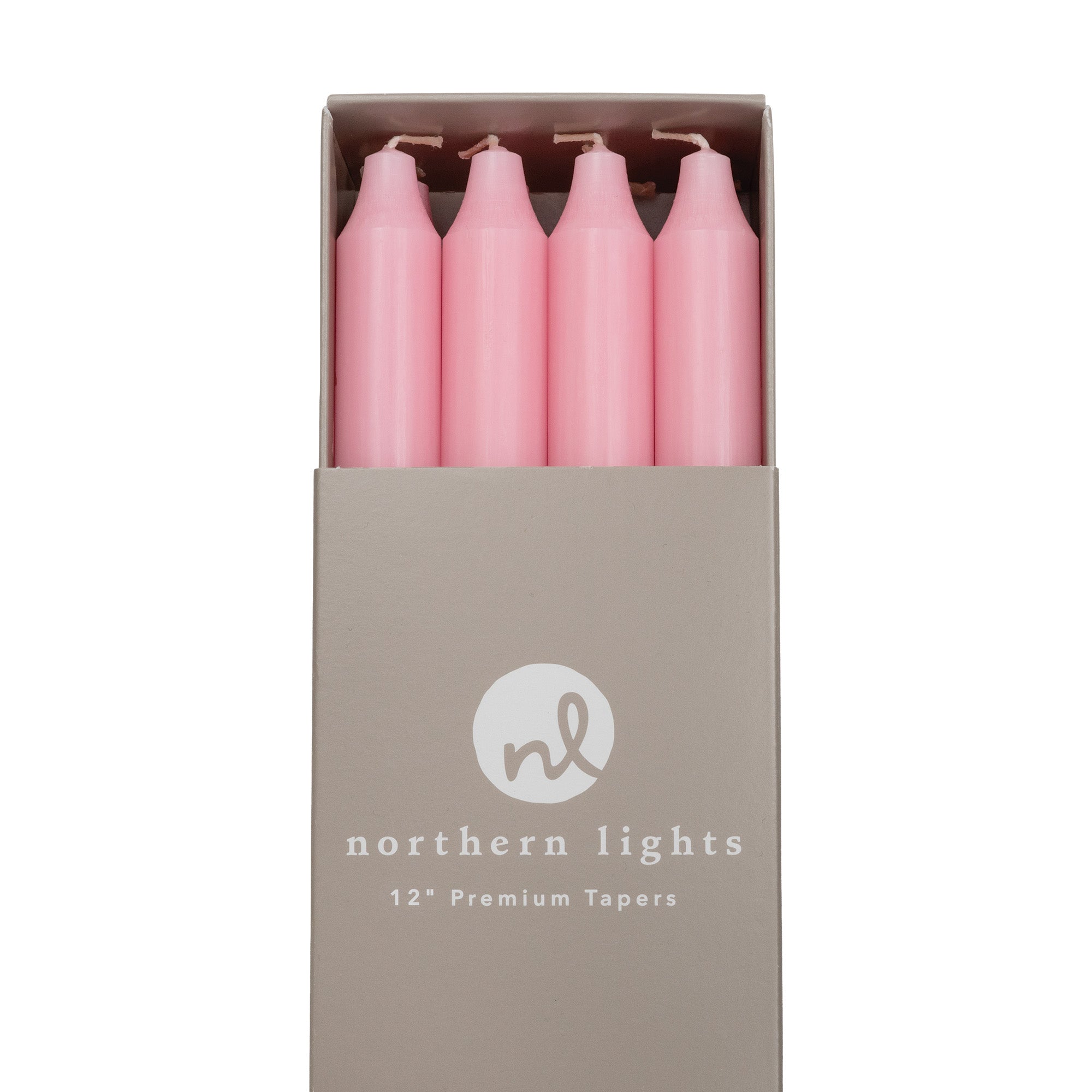 A box of soft pink 12 inch taper candles made by Northern Lights.