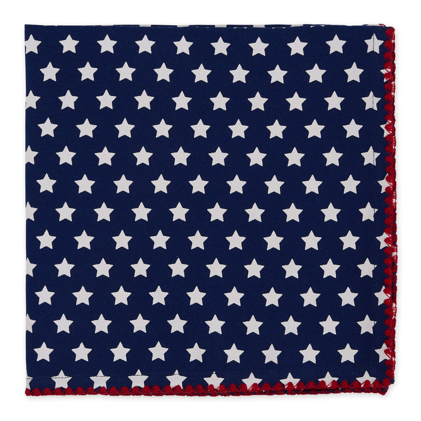 A blue napkin with white stars and a red trim on a white background.