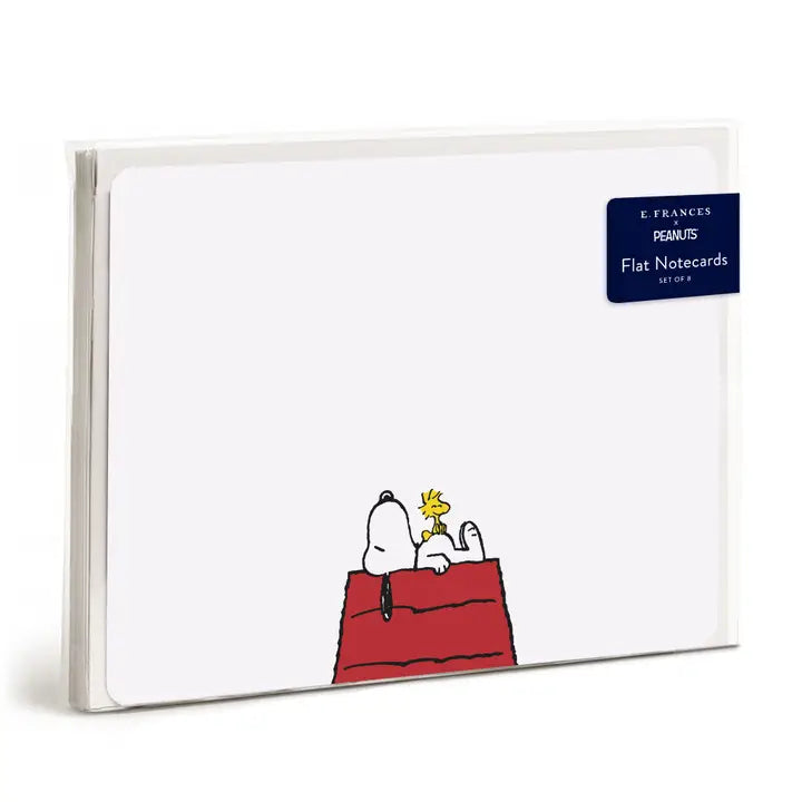 A pack of G. Francus Peanuts flat notecards featuring Snoopy and Woodstock on a red doghouse, shown in a clear plastic sleeve on a white background.