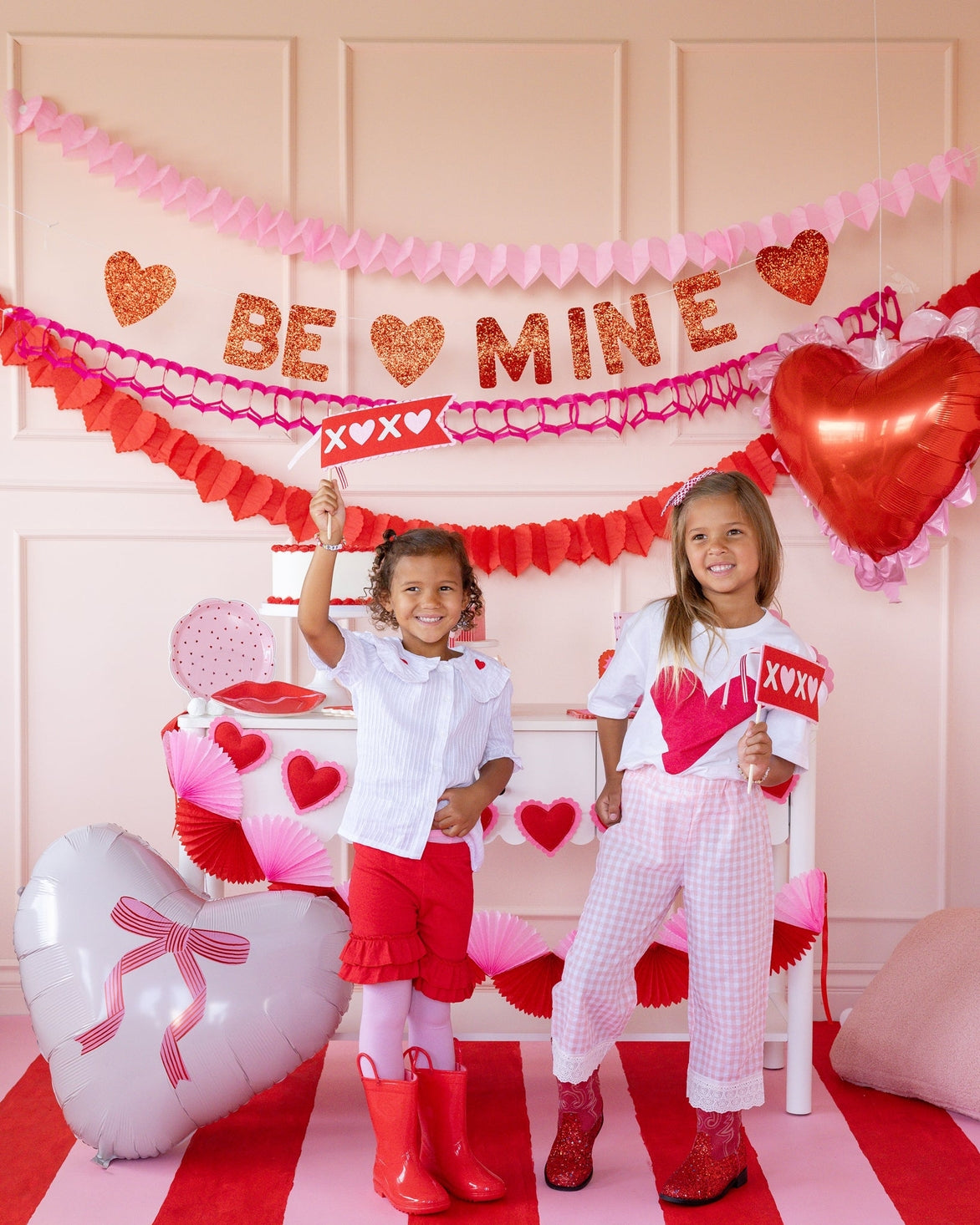 Two children in a decorated room with Valentine&