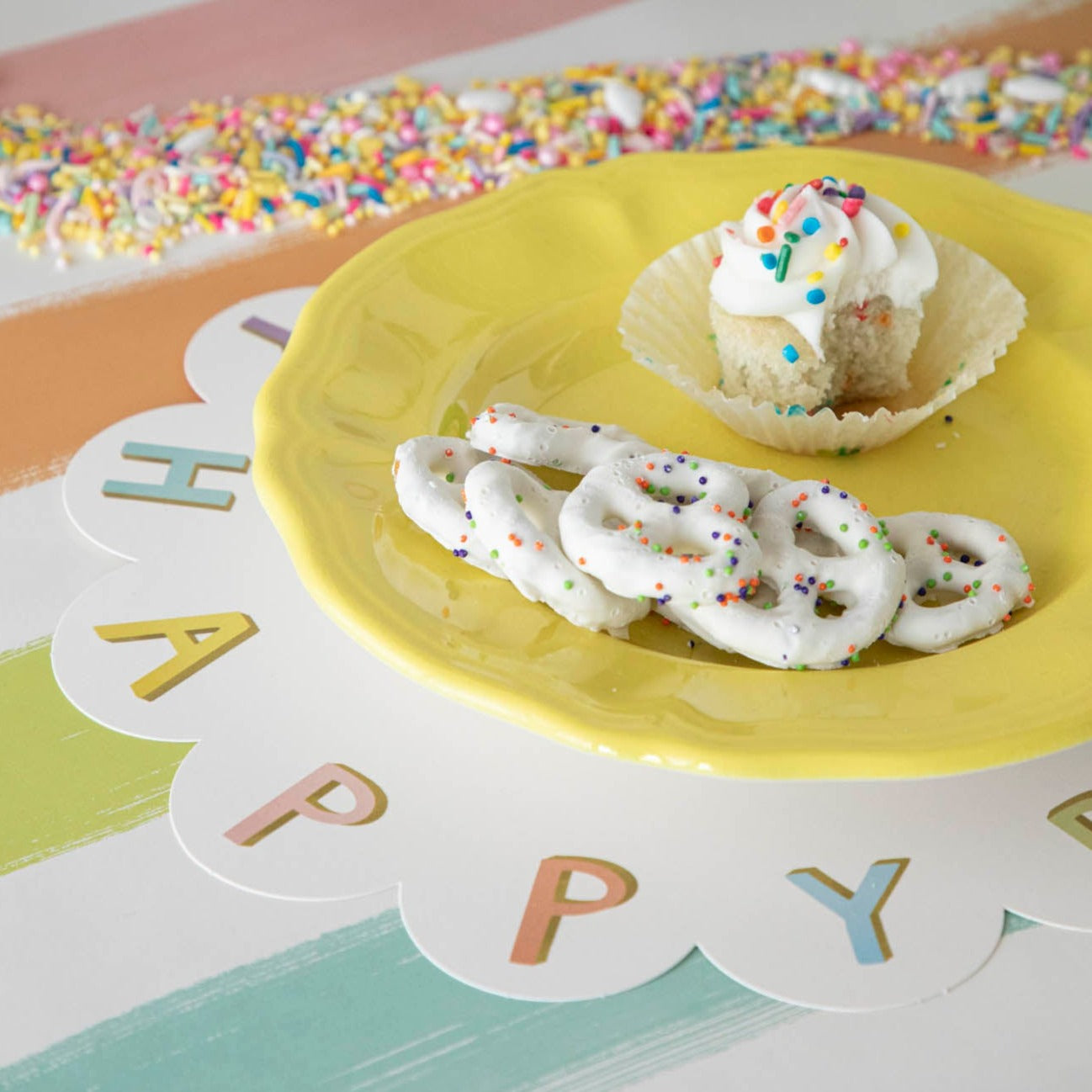 A Happy Birthday Serving Paper from Hester & Cook, with a cupcake and pretzels on it, perfect for charcuterie spreads.