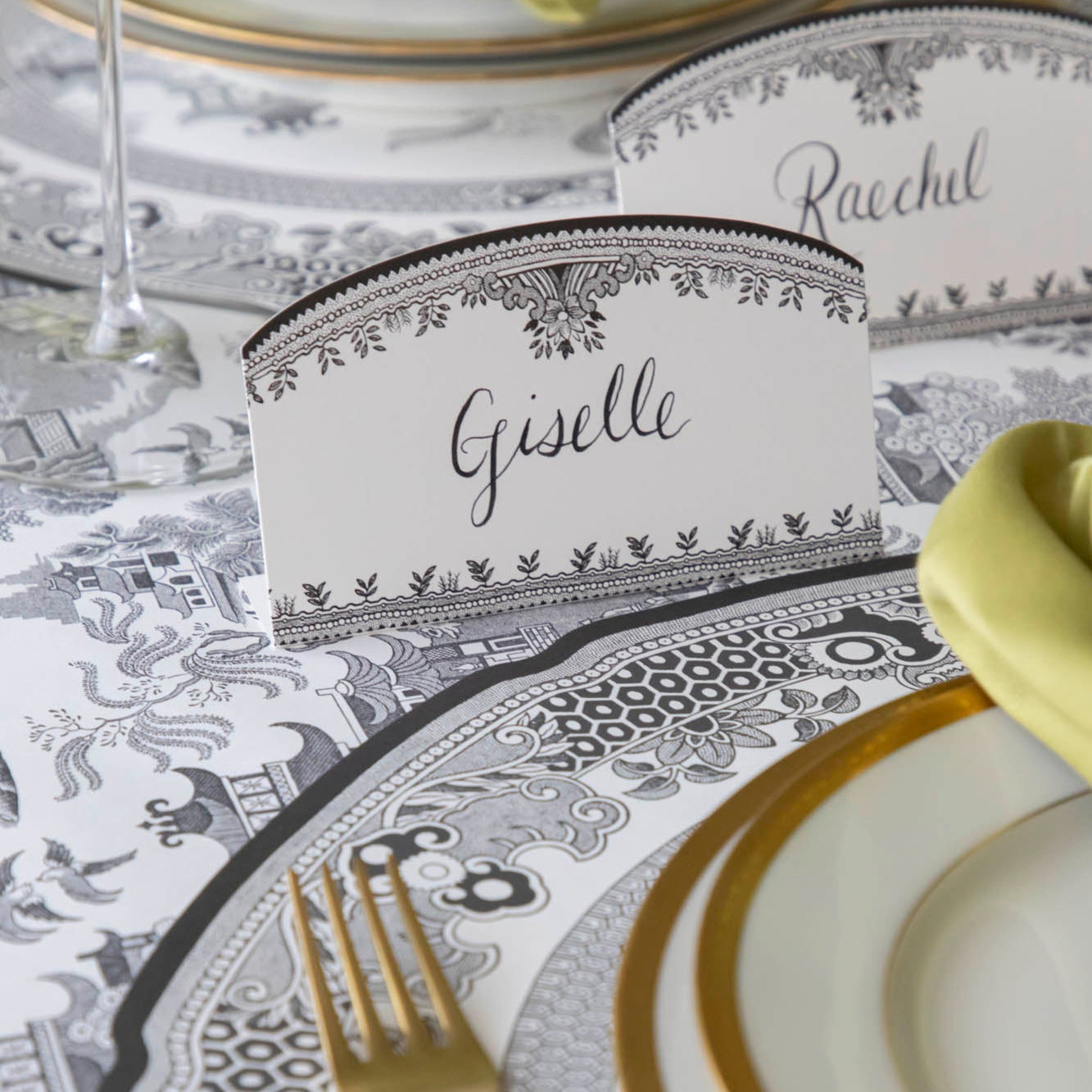 Black Willow Place Card with "Giselle" written on it, behind a place setting.
