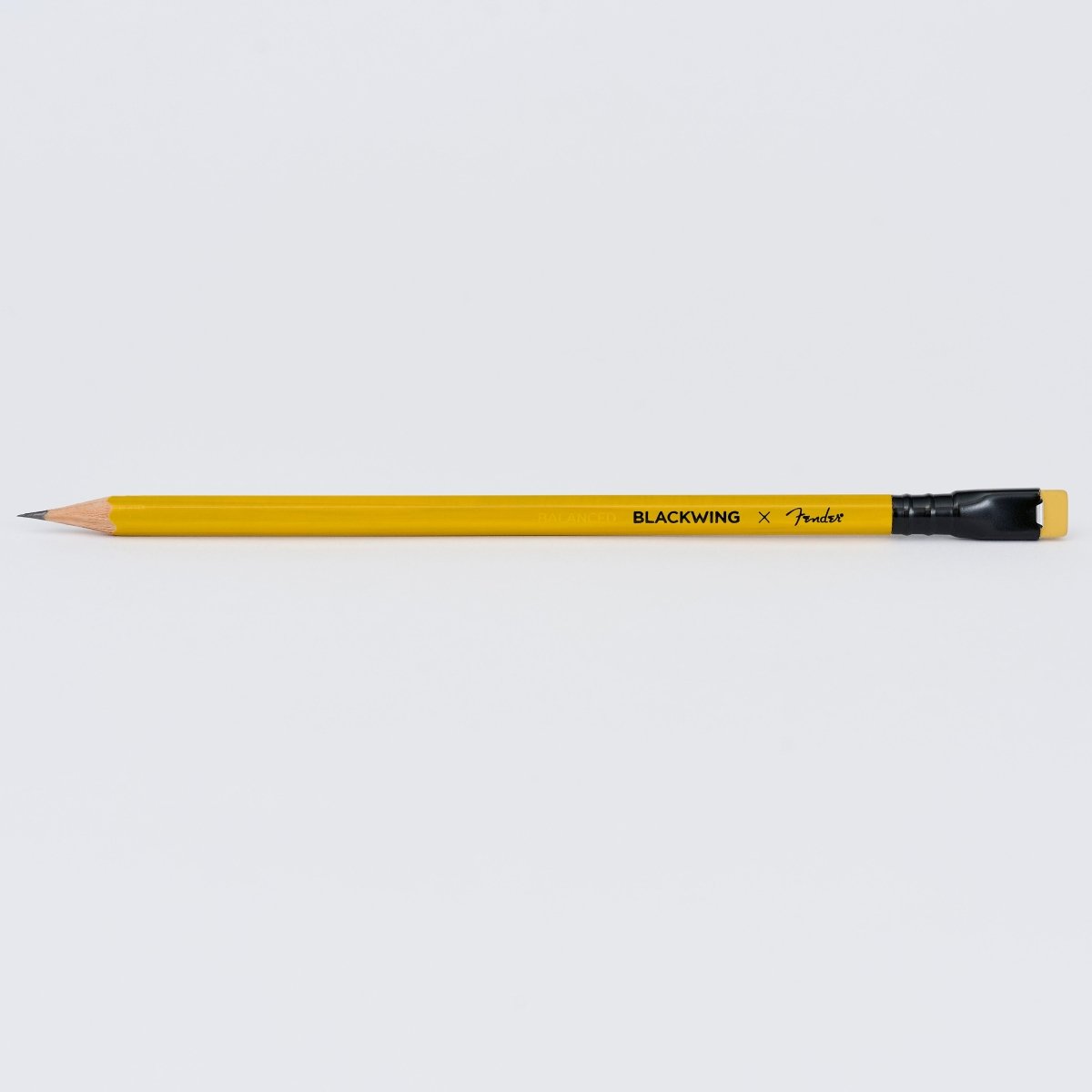 A yellow Fender Blackwing pencil with a black eraser and a natural wood tip, shown horizontally against a light gray background.