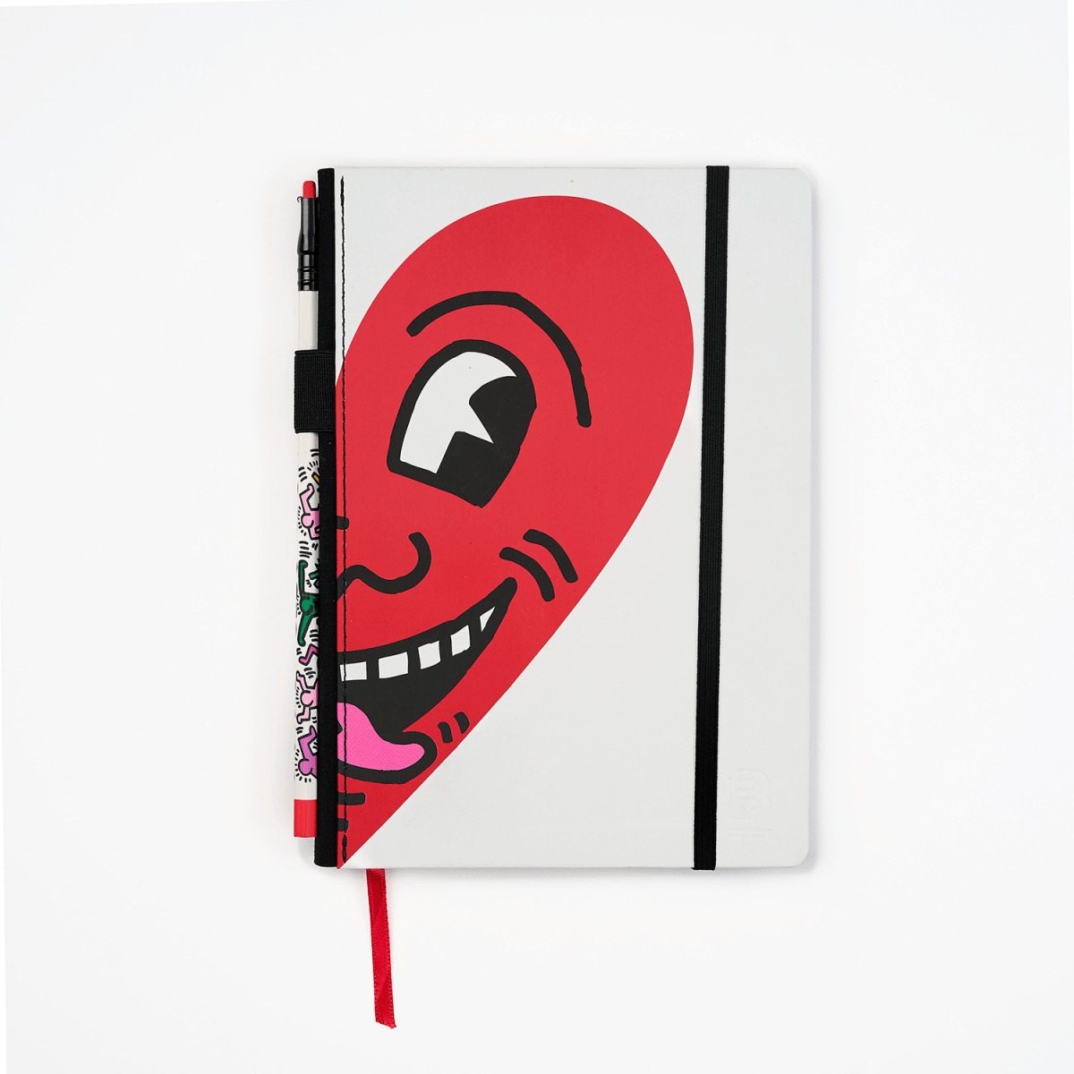 Blackwing notebook with Keith Haring artwork featuring a red heart with an eye and mouth on a white background.