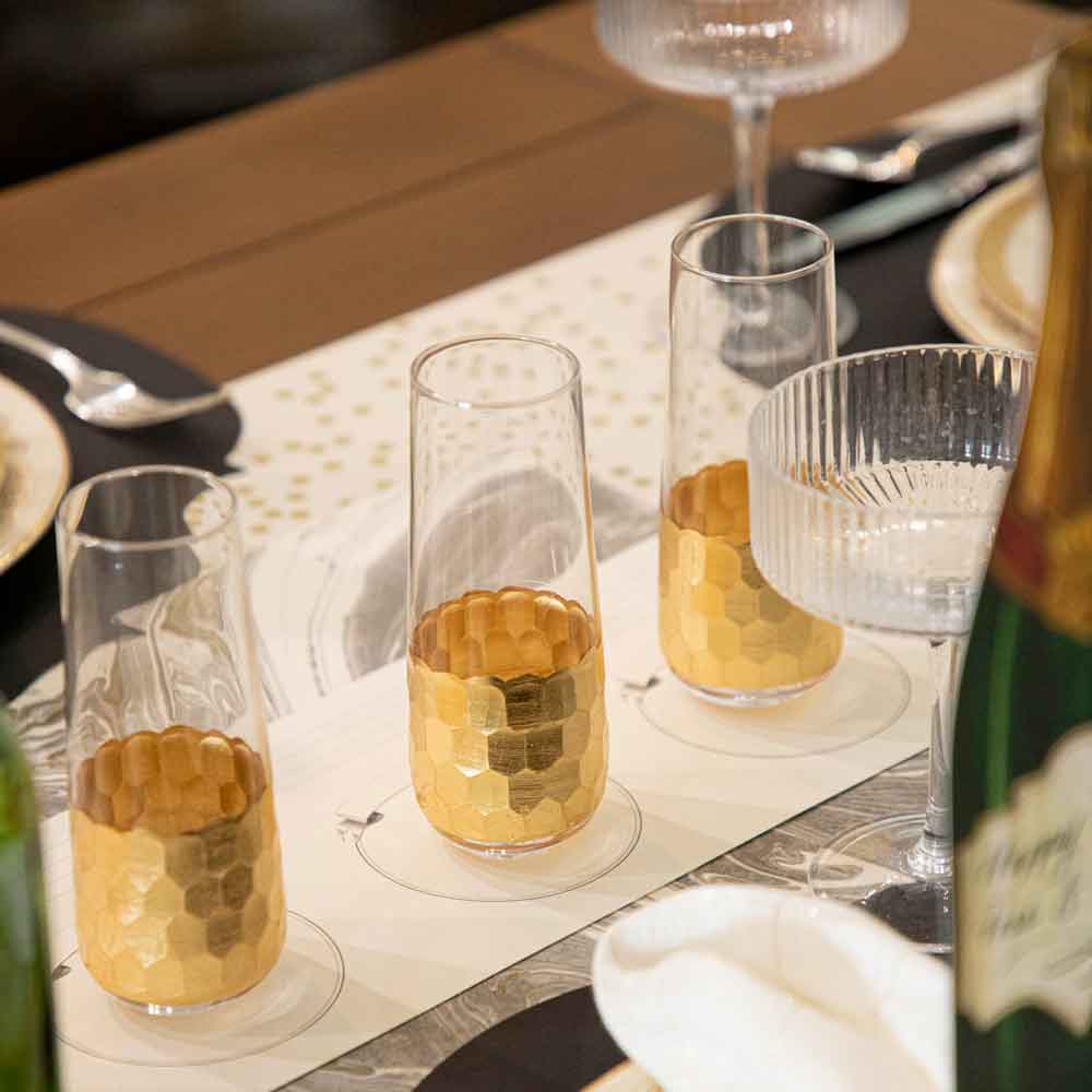 A table setting with Vitorrio Stemless Glassware plates, and napkins.