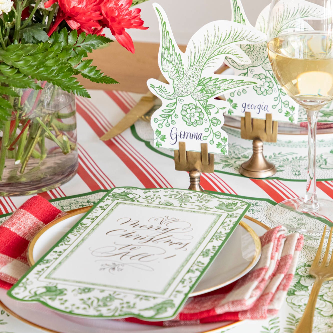 An elegant table setting featuring the Green Asiatic Pheasants Place Card with "Gemma" written on it, paired with the Green Regal Peacock Placemat and table card.