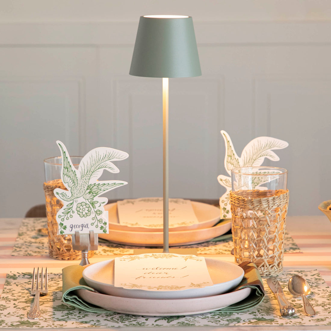 A table setting with place settings and a Zafferano Sage Cordless Lamp.