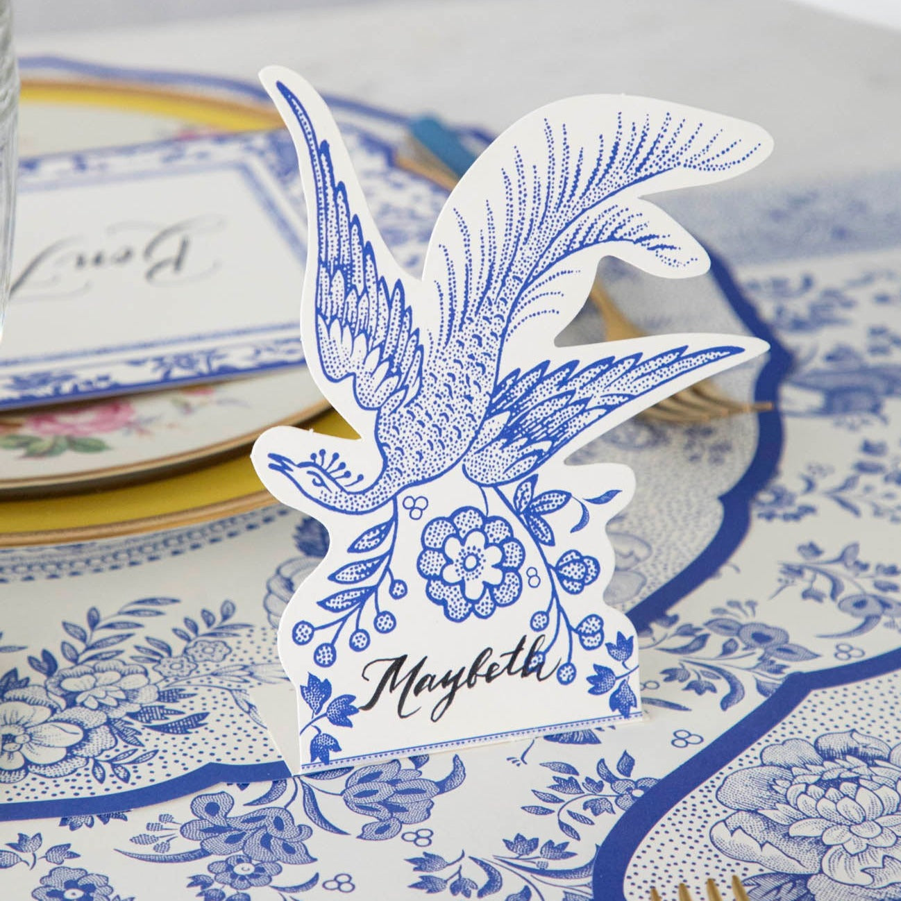 A Blue Asiatic Pheasants place card with a bird on it, perfect for buffet labels or as part of the Hester & Cook Burleigh collaboration.