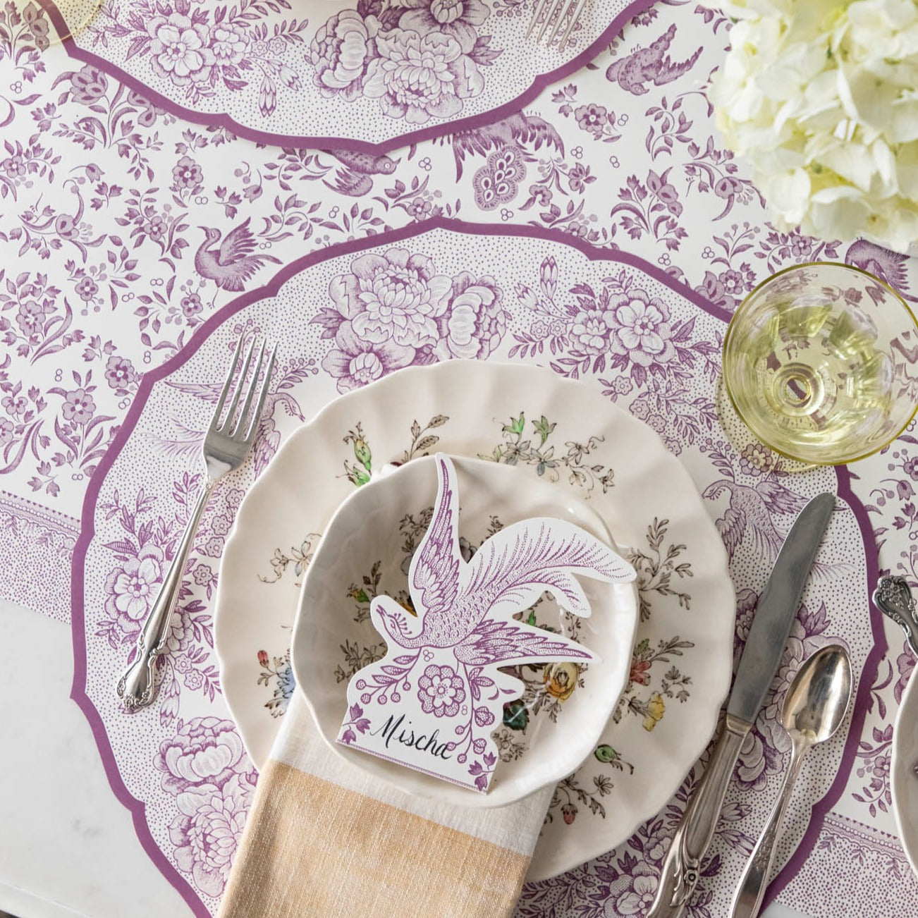 The Die-cut Lilac Asiatic Pheasants Placemat in an elegant table setting, at an angle.