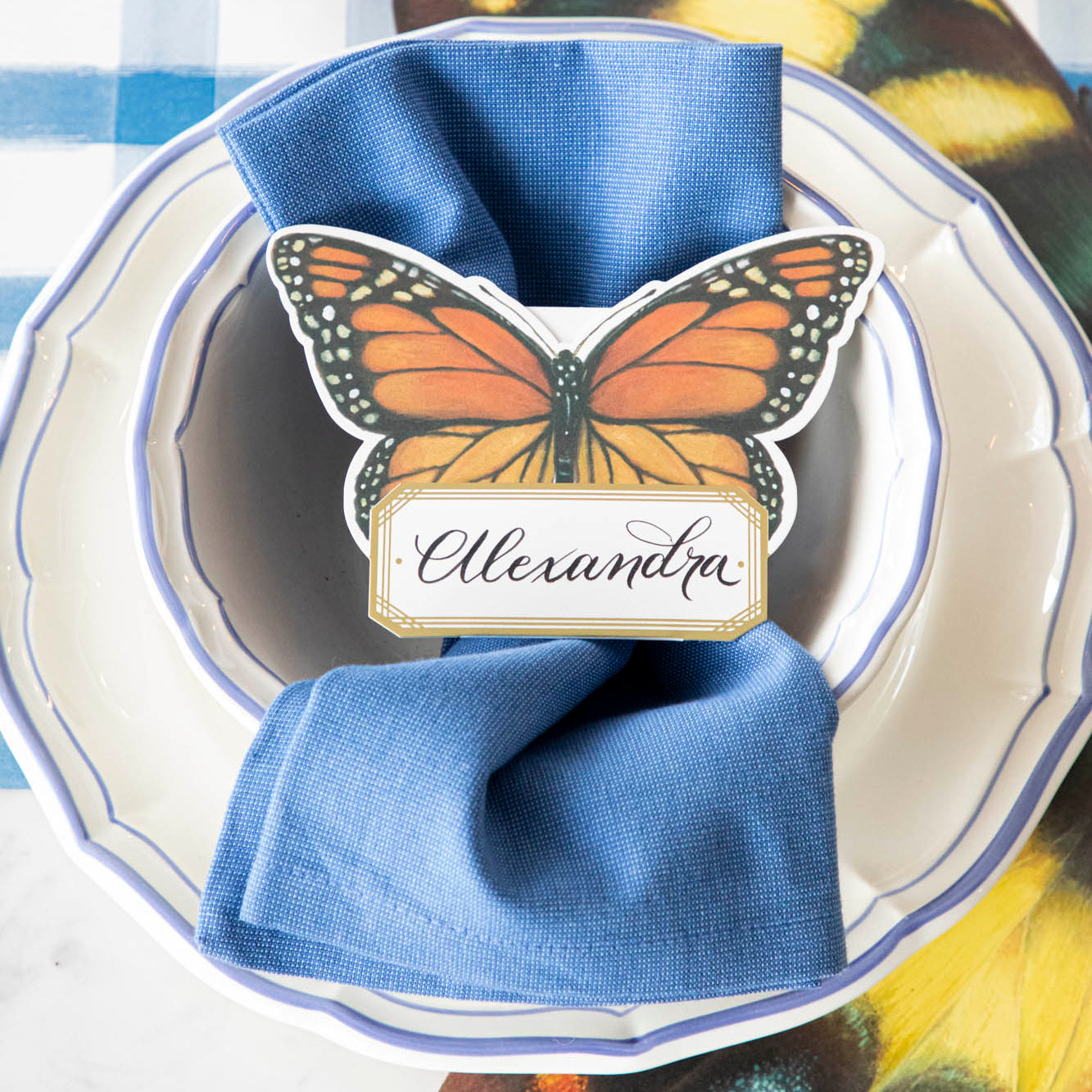 Monarch Butterfly Place Card with "Alexandra" written on it, on a butterfly themed place setting.