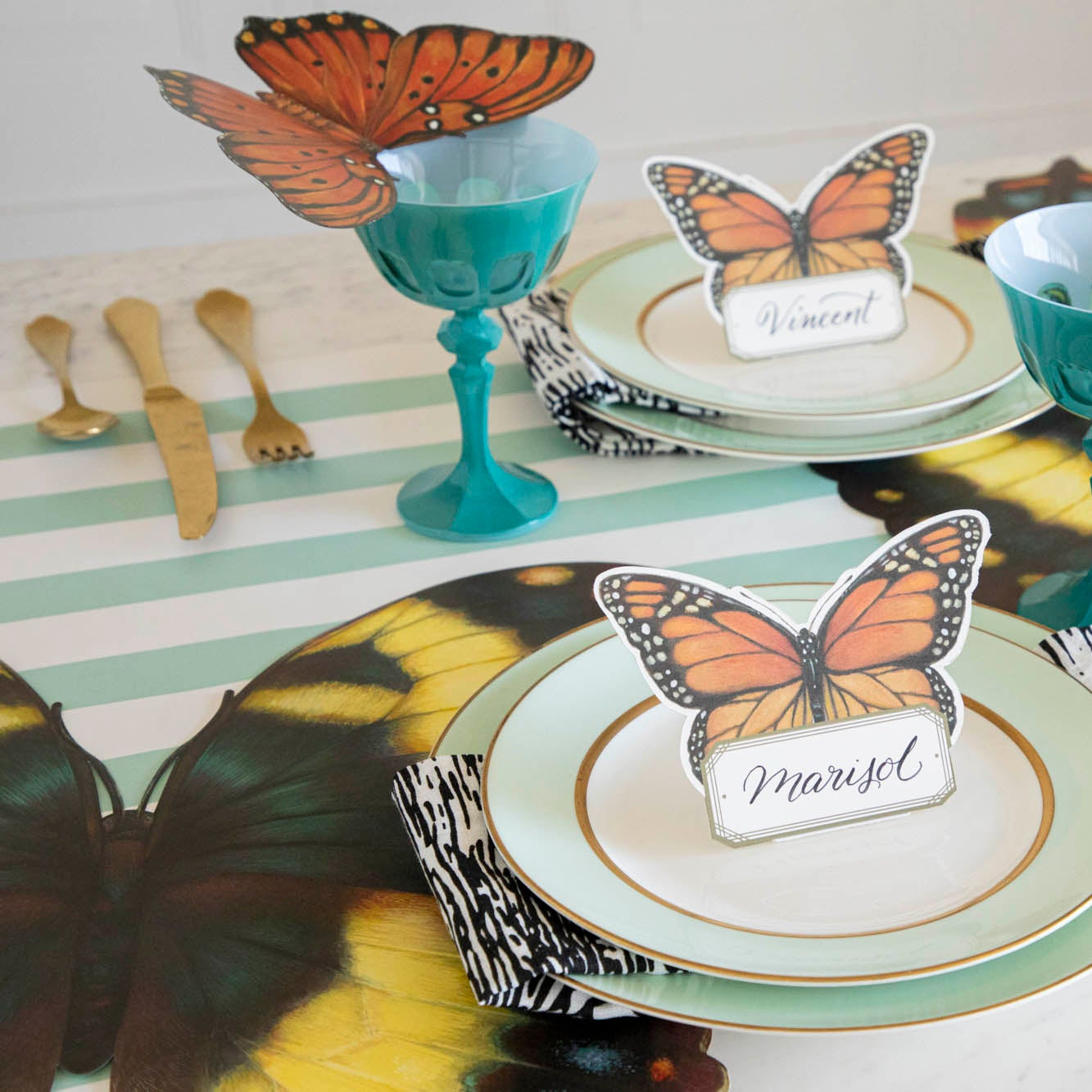 An elegant butterfly-themed table setting featuring Die-cut Butterfly Placemats at each place.