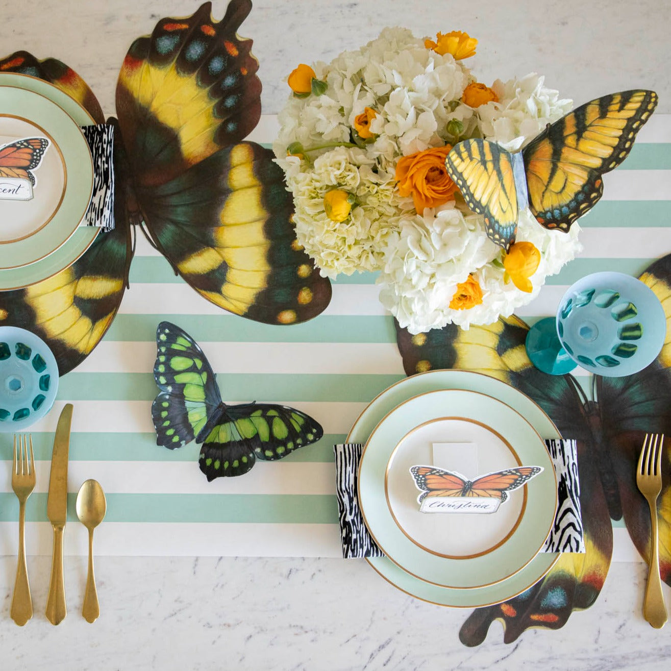 Top-down view of an elegant butterfly-themed tablescape, featuring Butterflies Table Accents scattered amongst the decor.