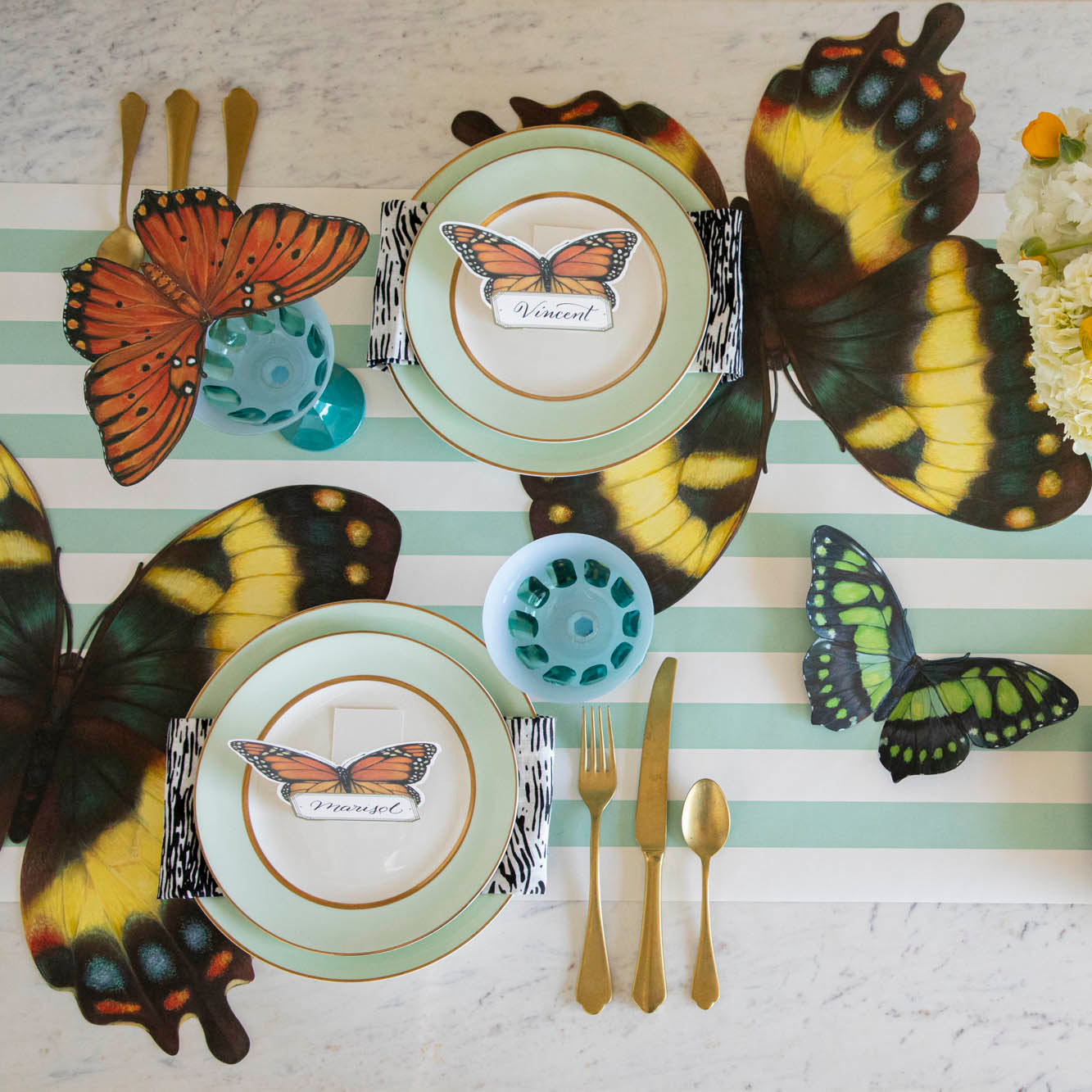 Overhead view of an elegant butterfly-themed tablescape featuring Die-cut Butterfly Placemats.