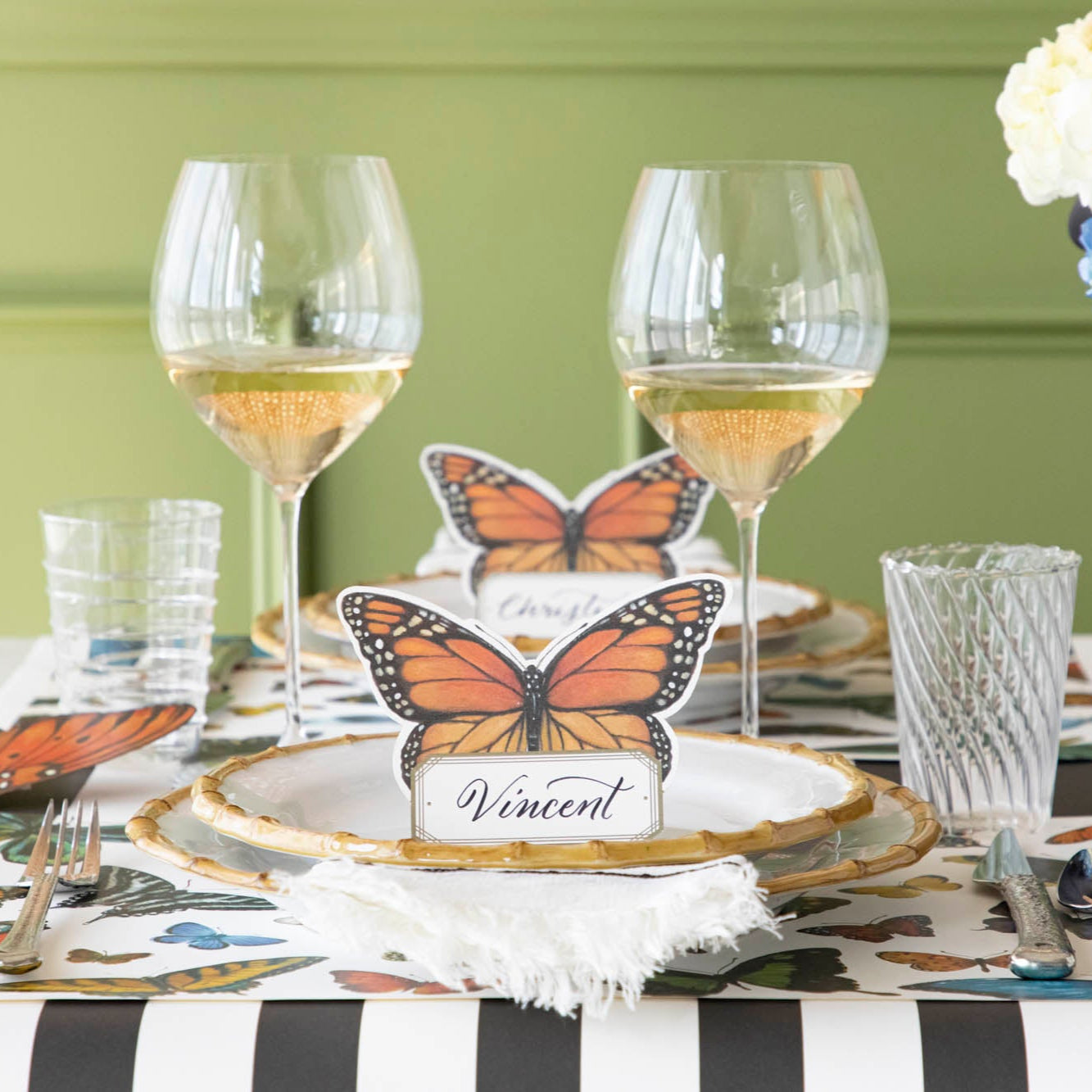 A variety of colorful butterflies displayed against a light background on Hester & Cook&