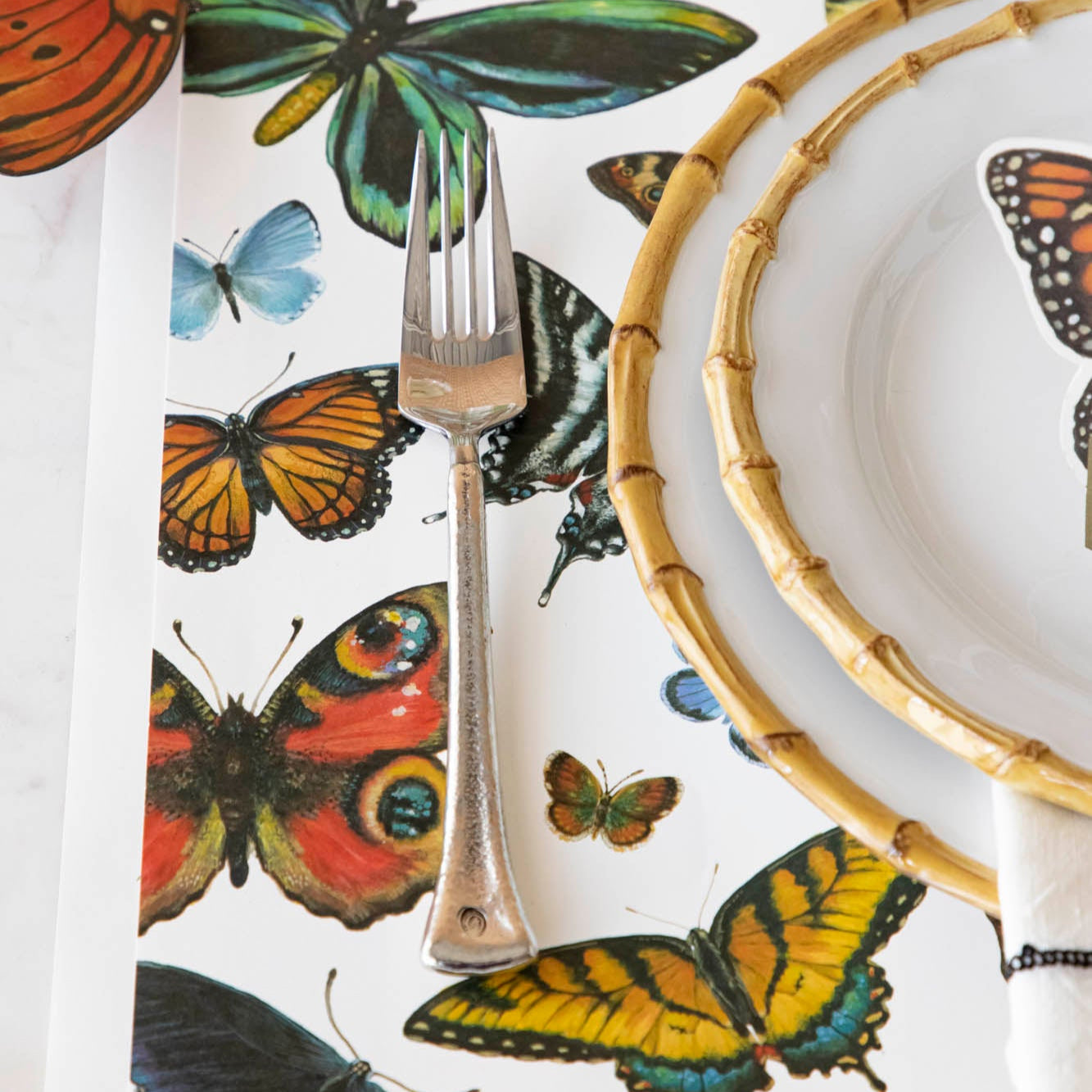 A variety of colorful butterflies displayed against a light background on Hester & Cook&