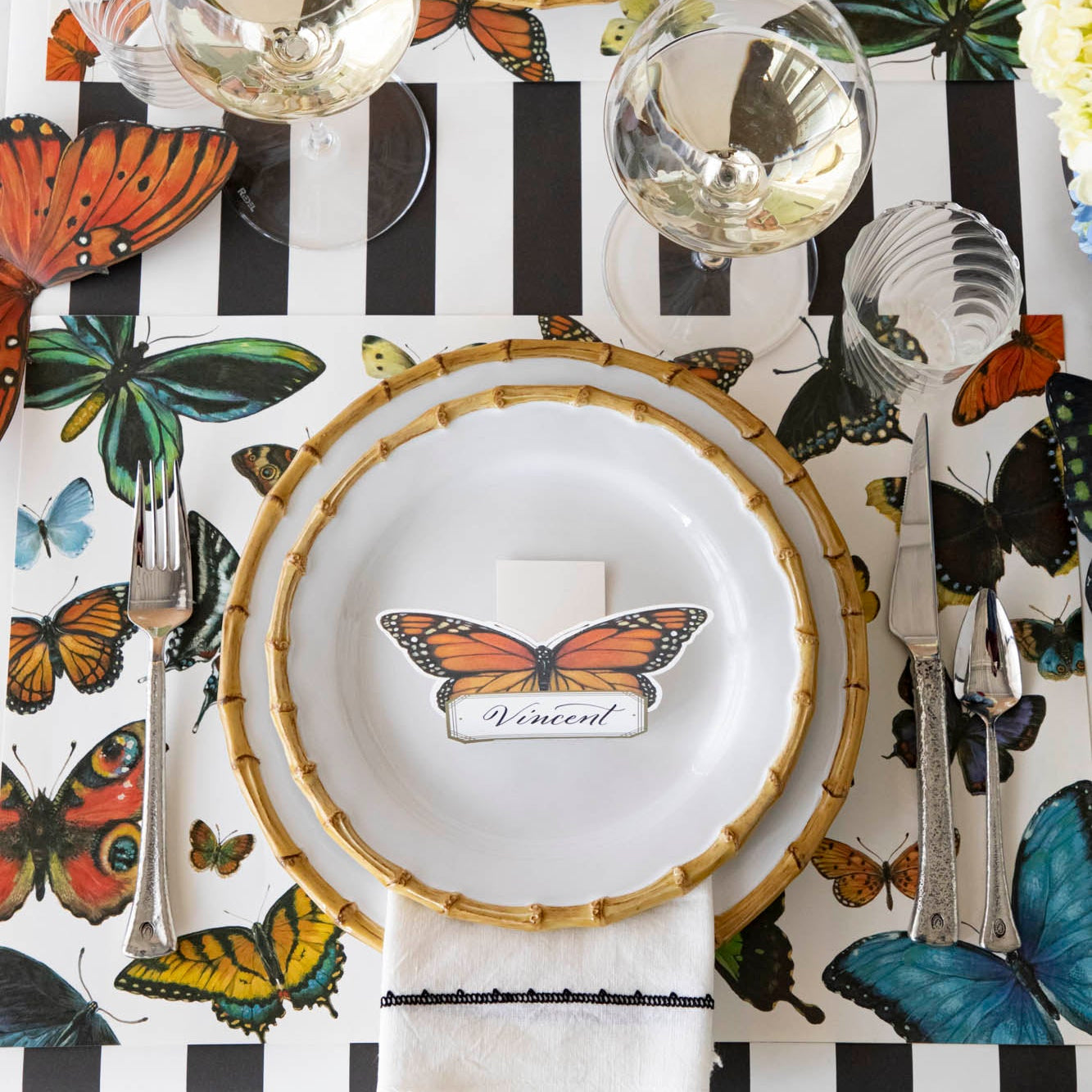 A variety of colorful butterflies displayed against a light background on Hester & Cook&