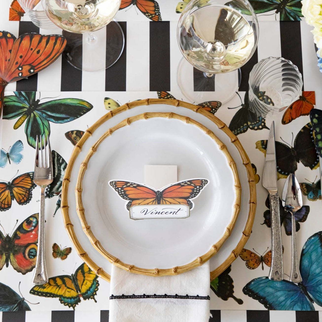 An elegant butterfly-themed tablescape featuring Monarch Butterfly Place Cards standing on each plate.