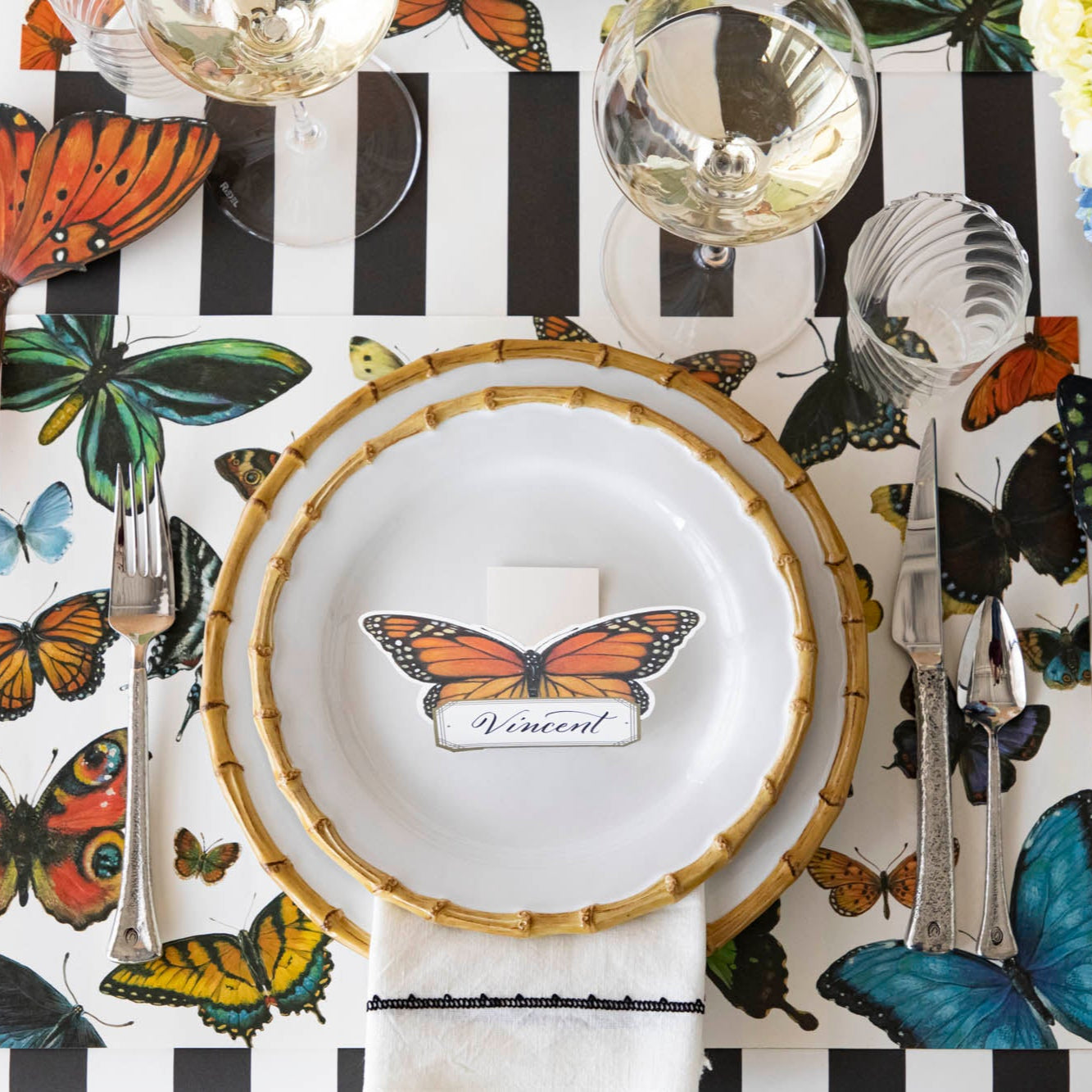 A variety of colorful butterflies displayed against a light background on Hester & Cook&