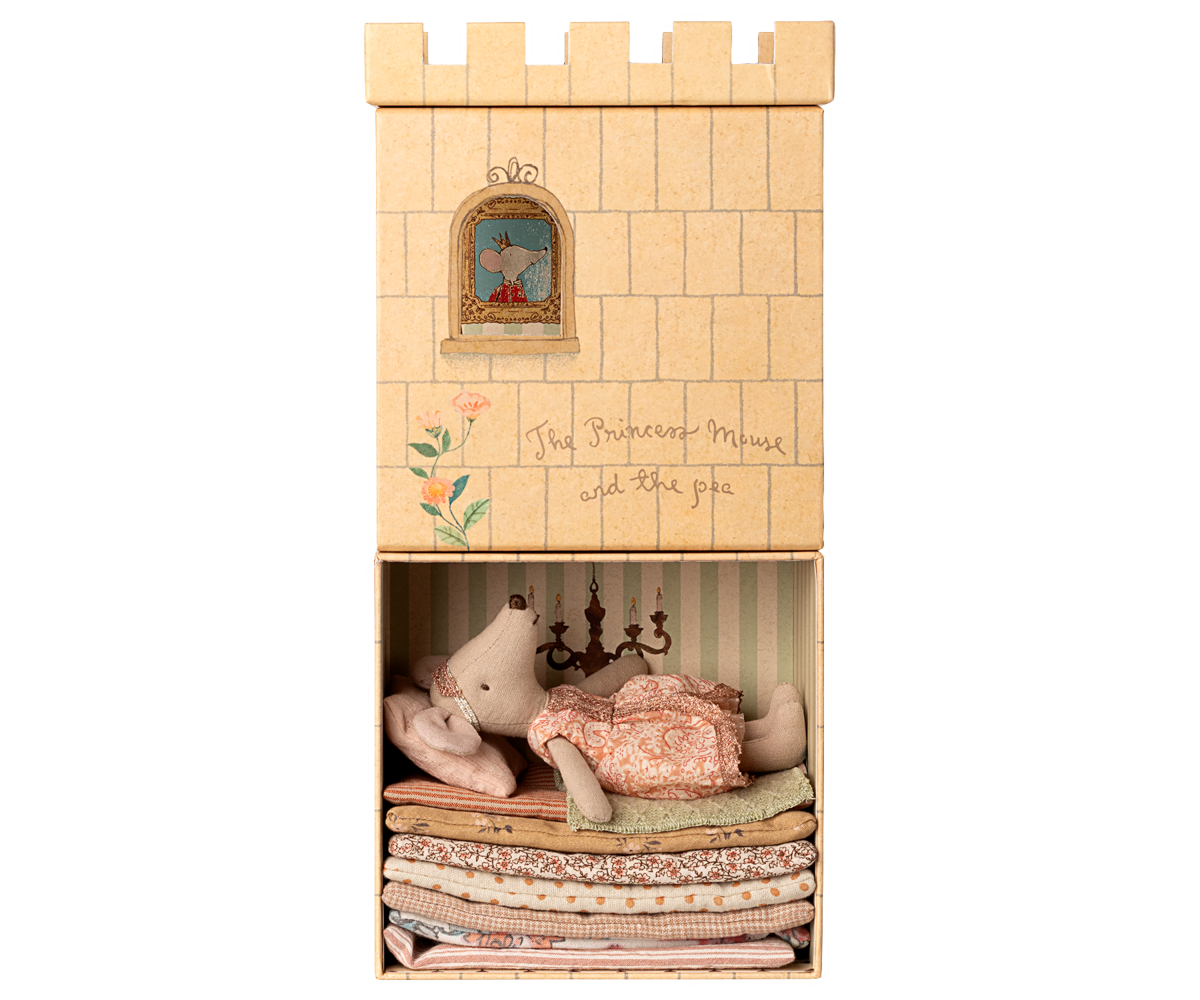 Toy castle with a princess mouse inside on a white background.