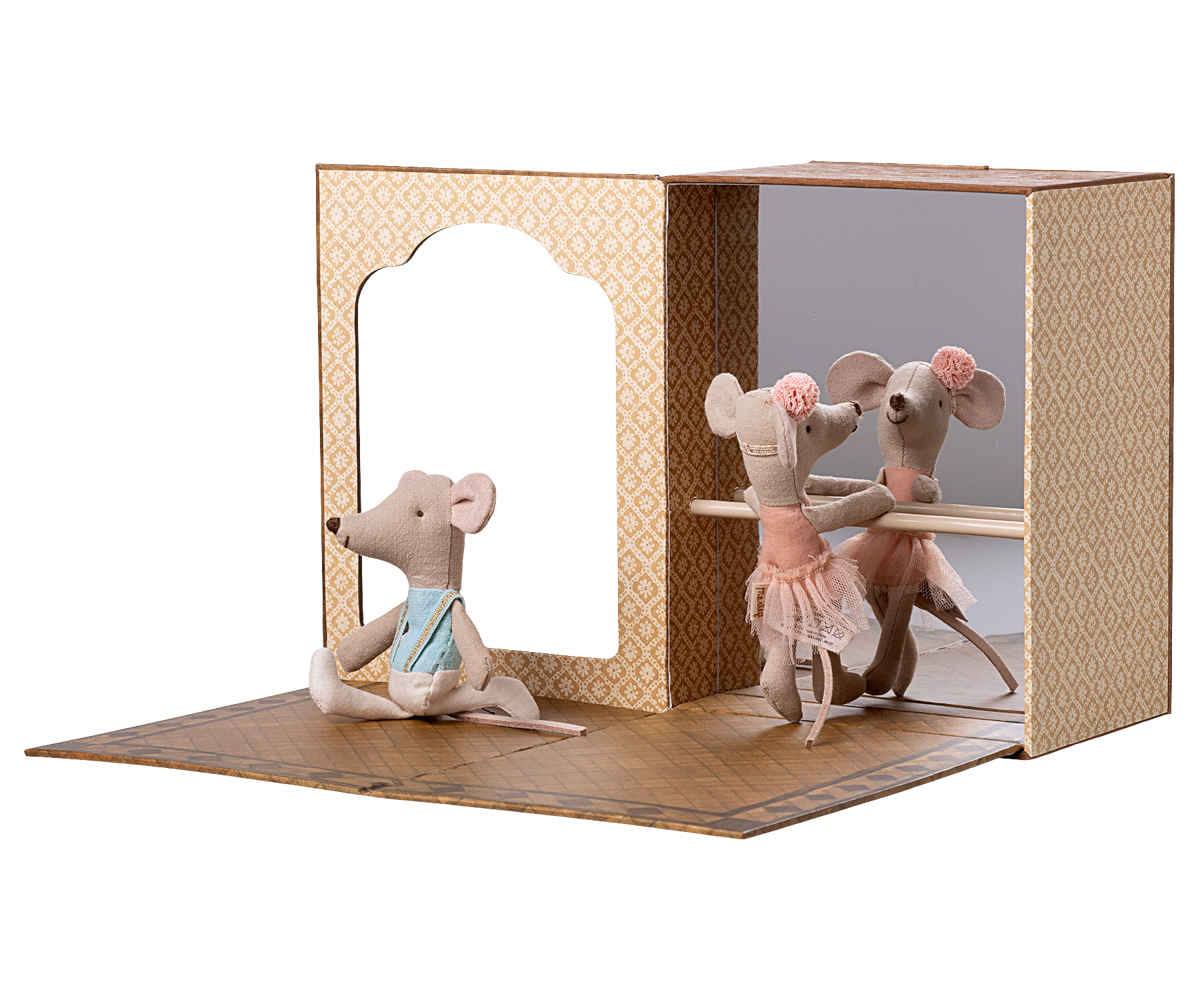 Toy mouse figures in a display case that looks like a ballet studio with a white background.